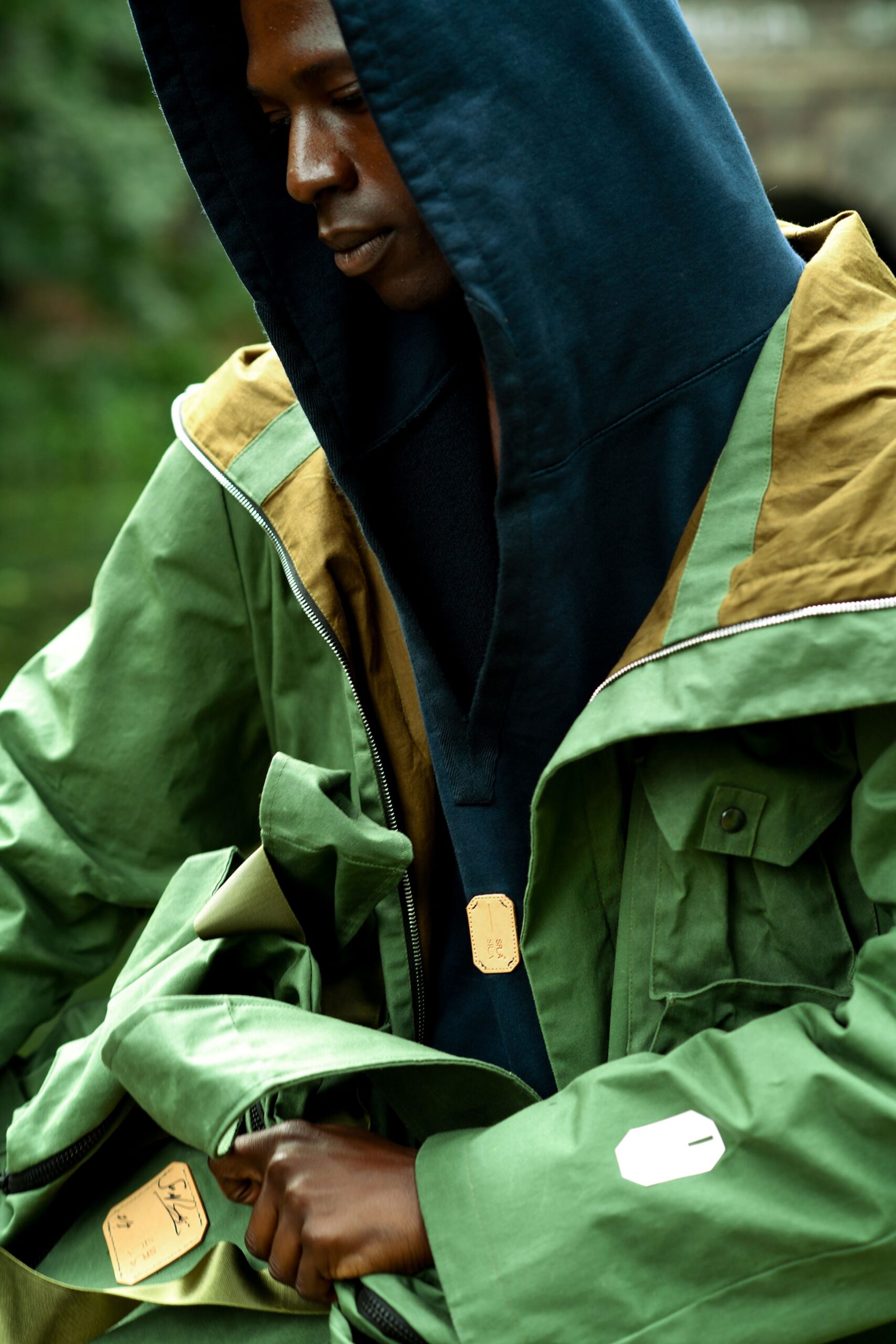 green jacket and black hoodie