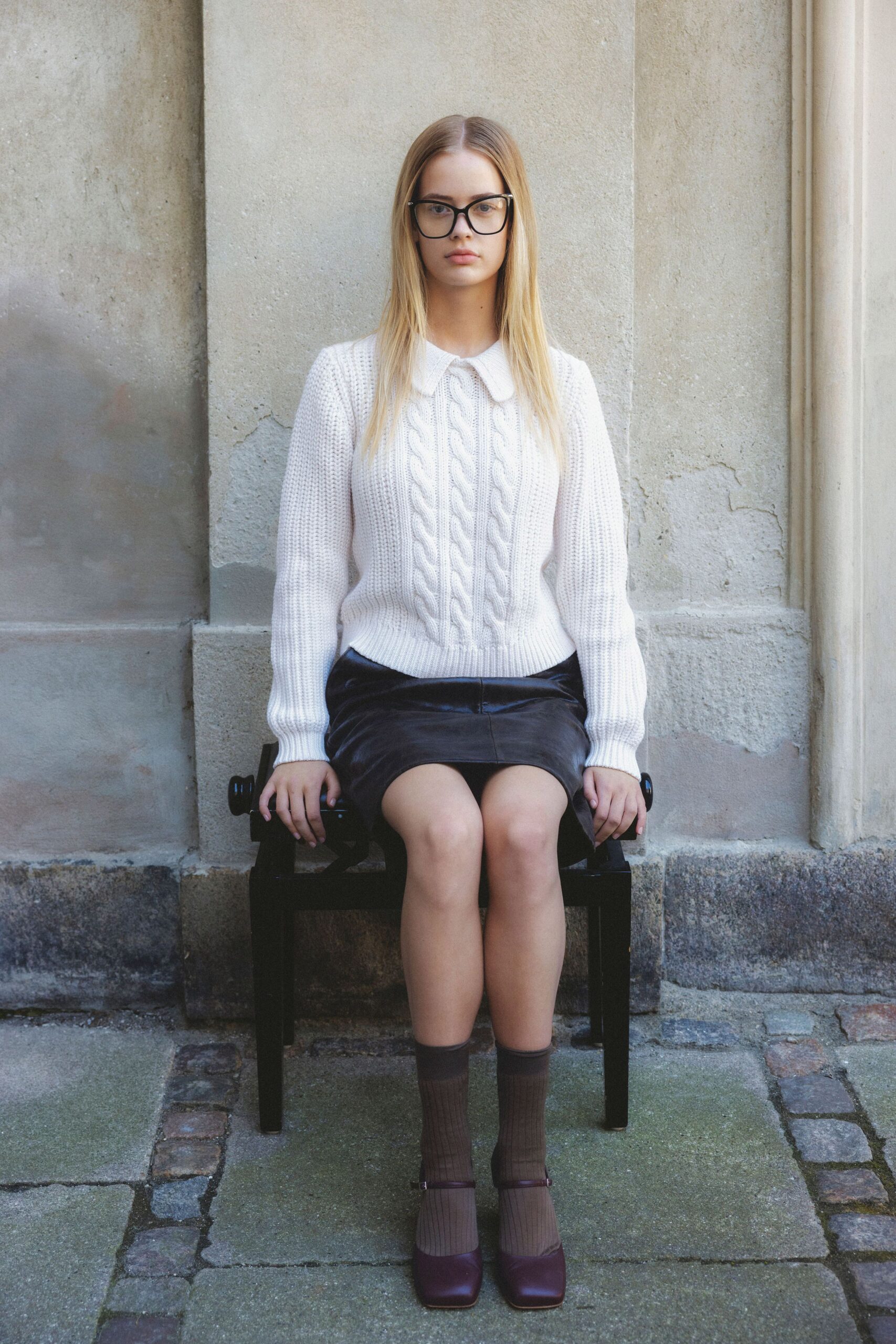 white cable-knit sweater black pencil skirt