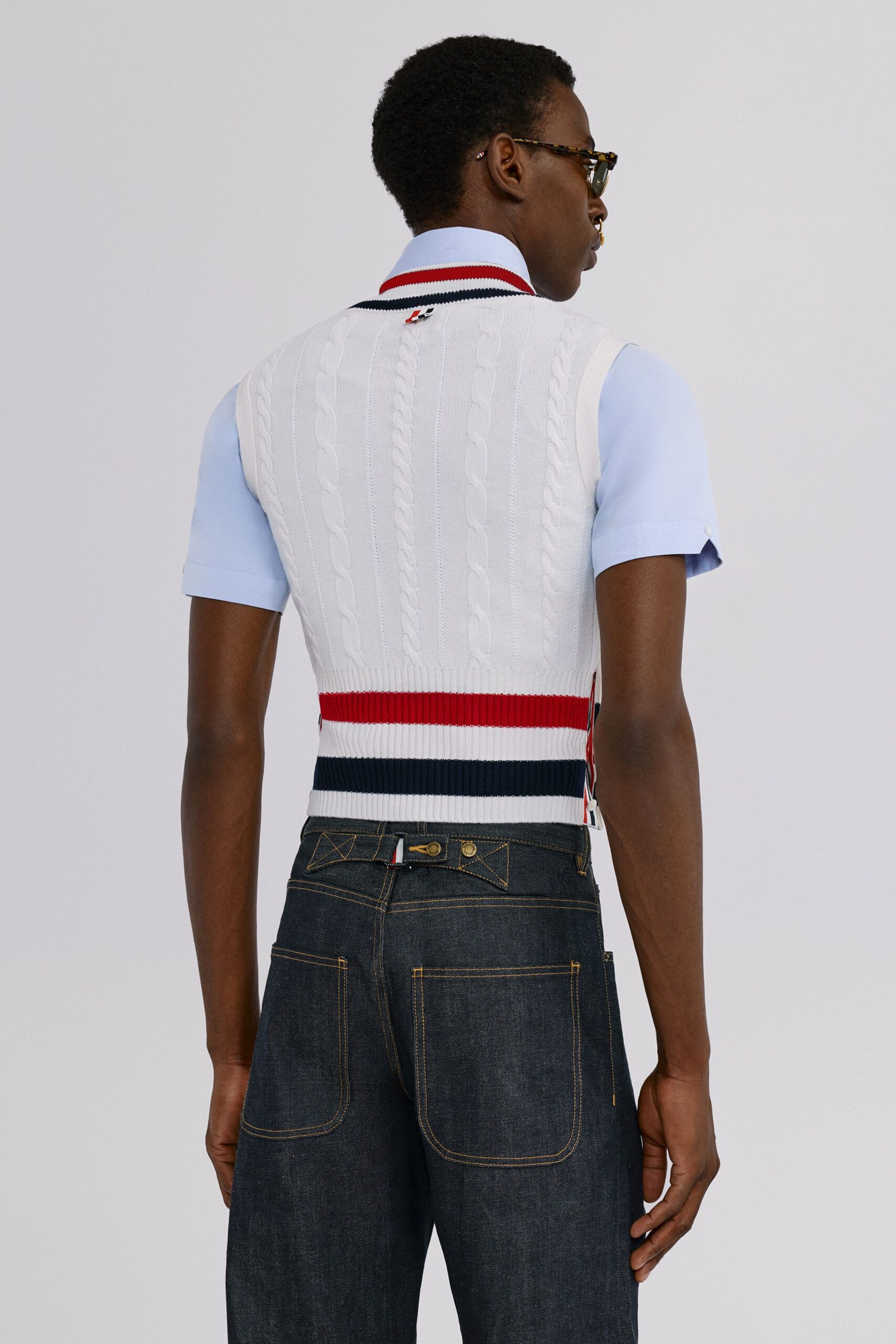 white cable-knit vest with blue shirt