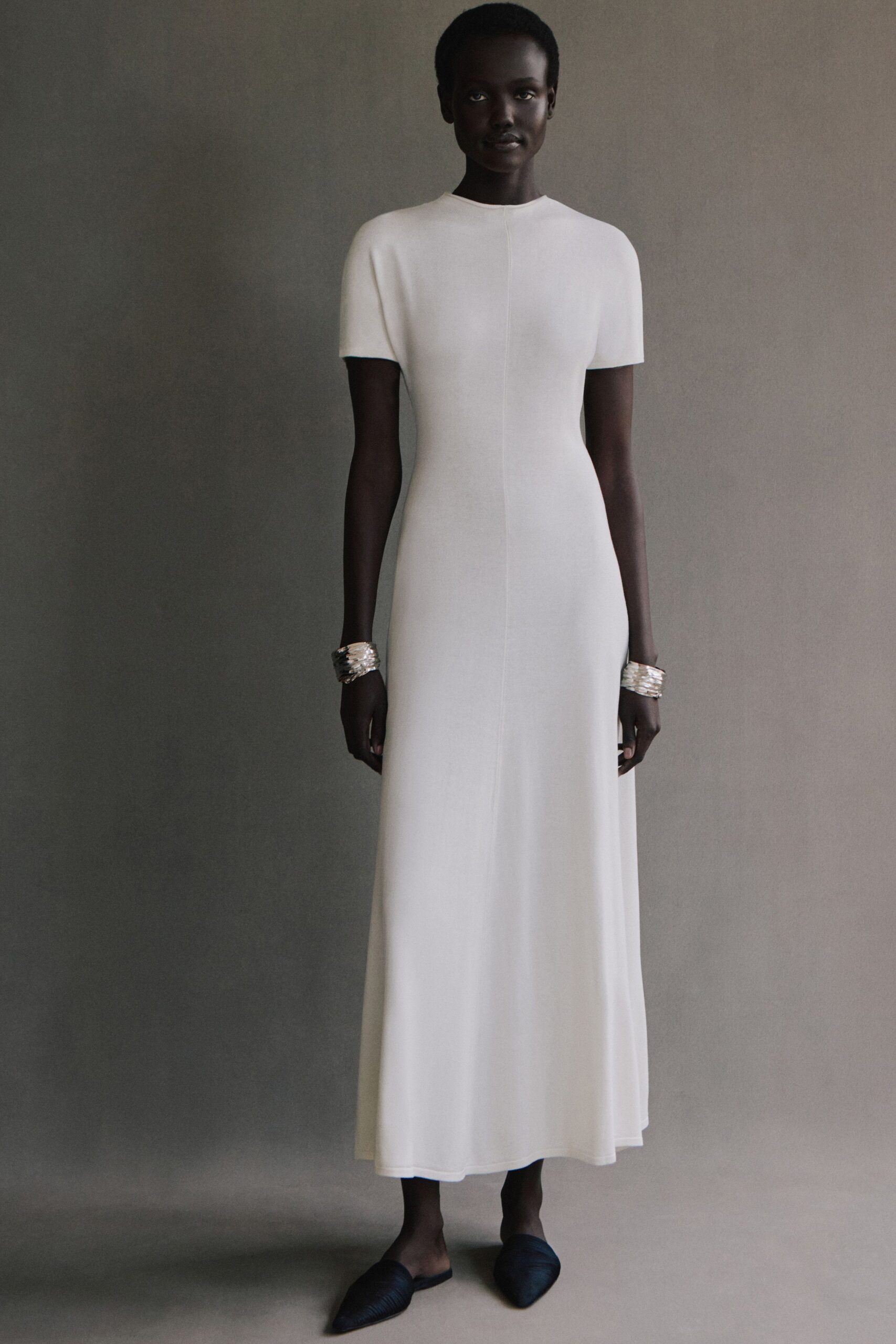 white fitted gown with black shoes