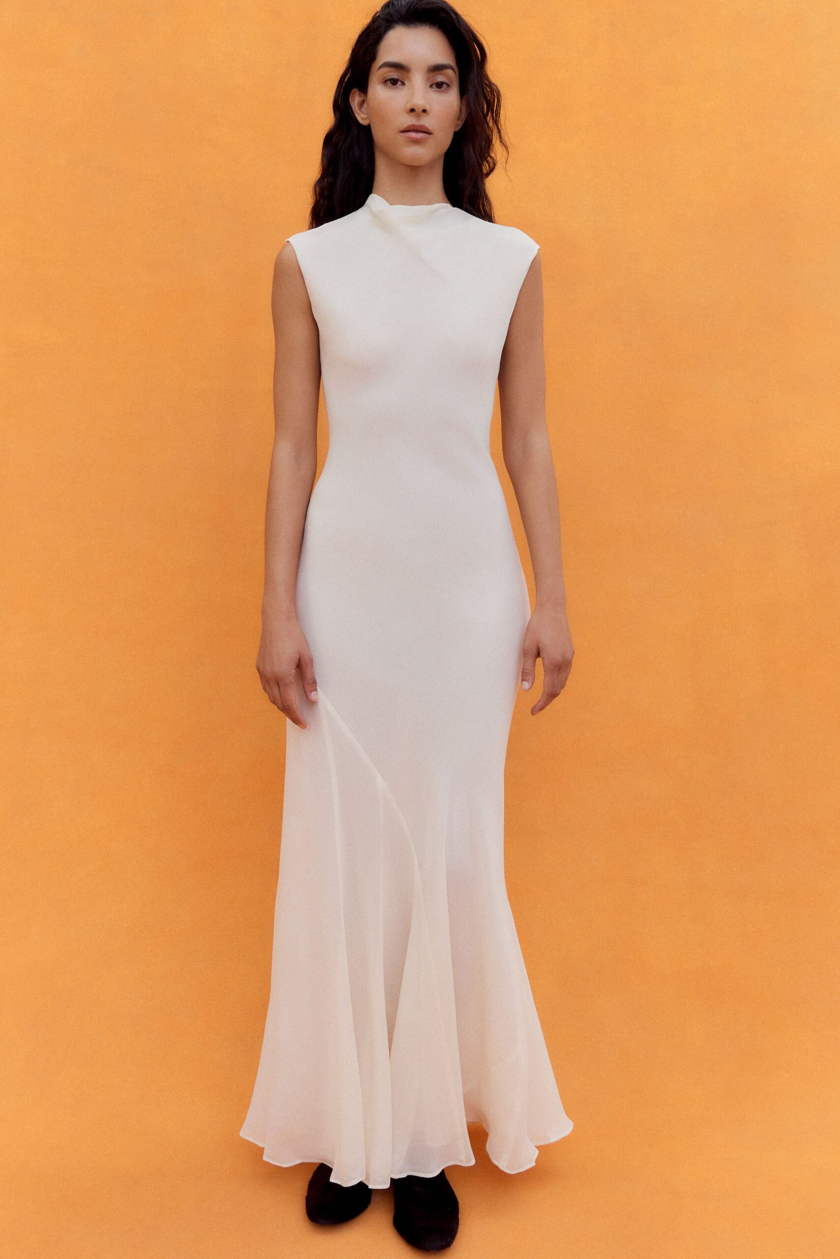 white silk sleeveless high-neck fitted flared flowing gown