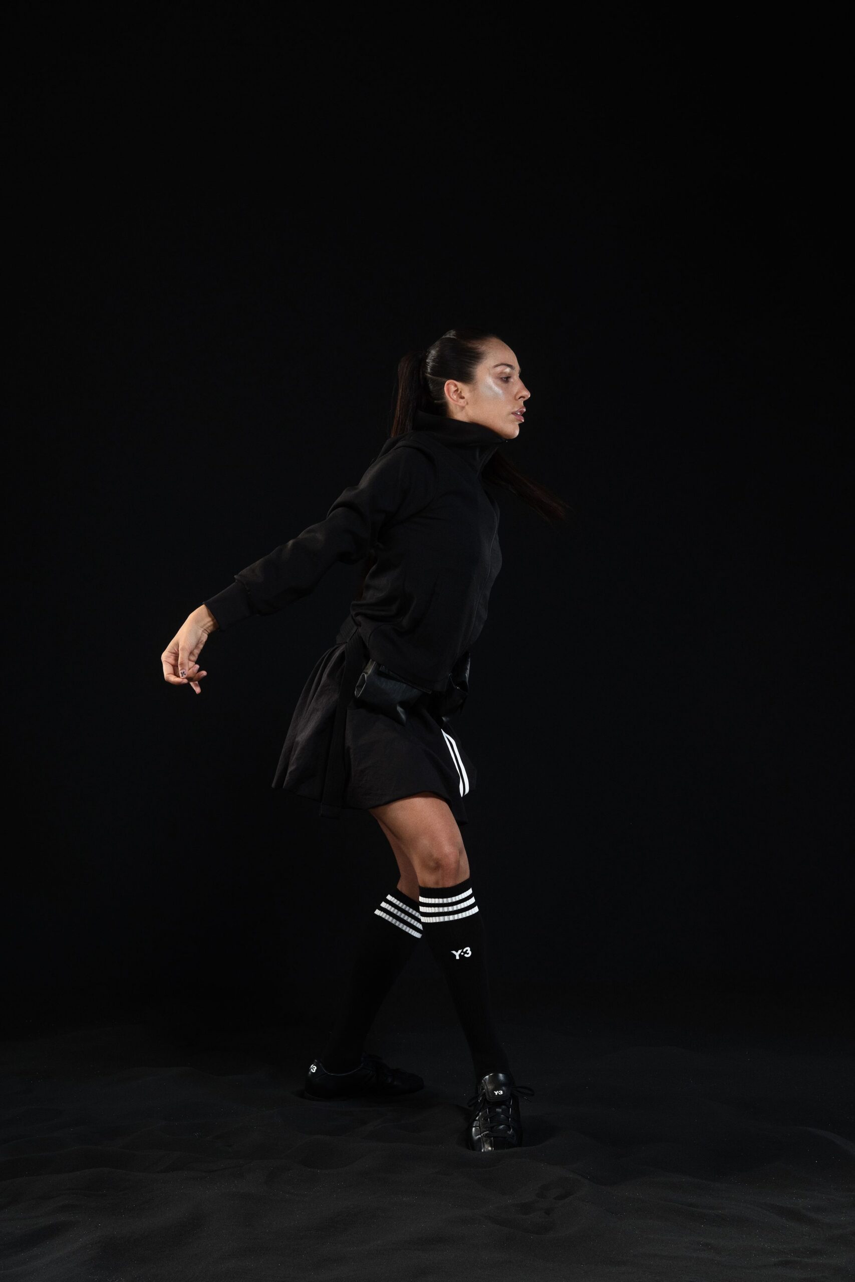 black fitted jacket and pleated skirt