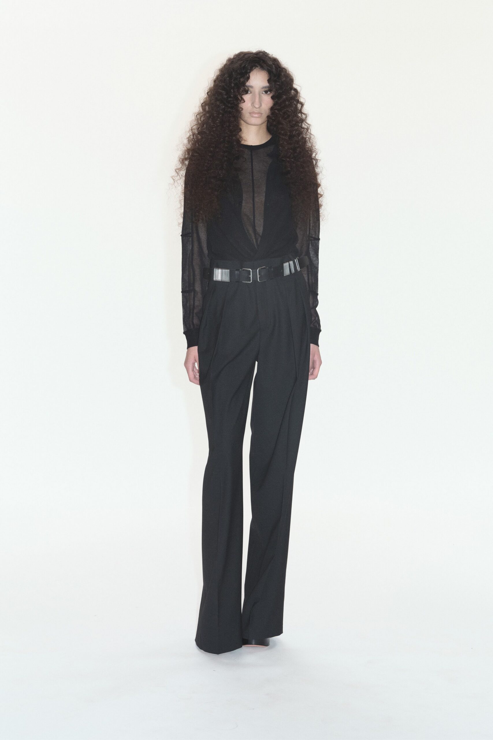 black fitted mesh top and tailored pants