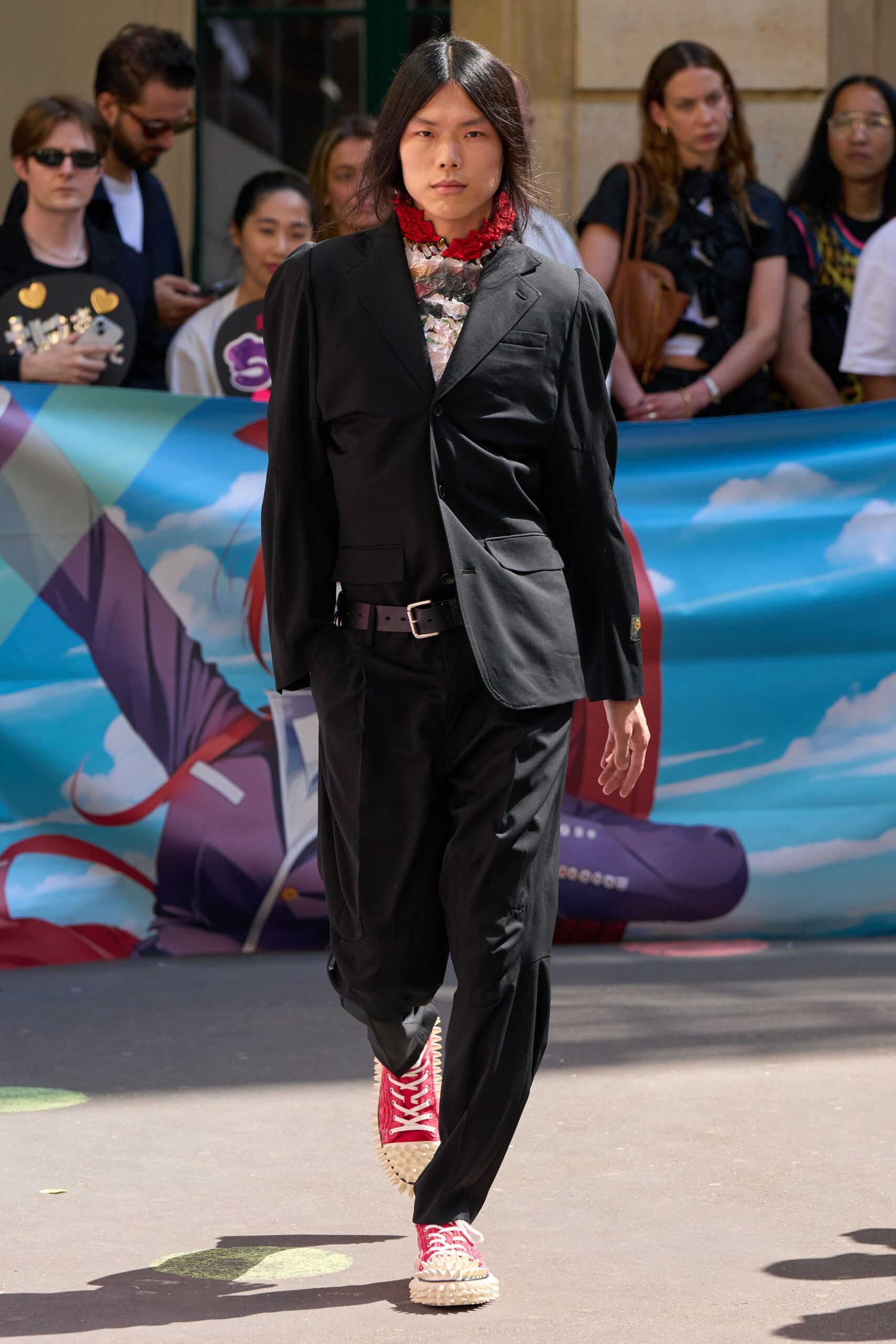 black fitted suit with red shoes