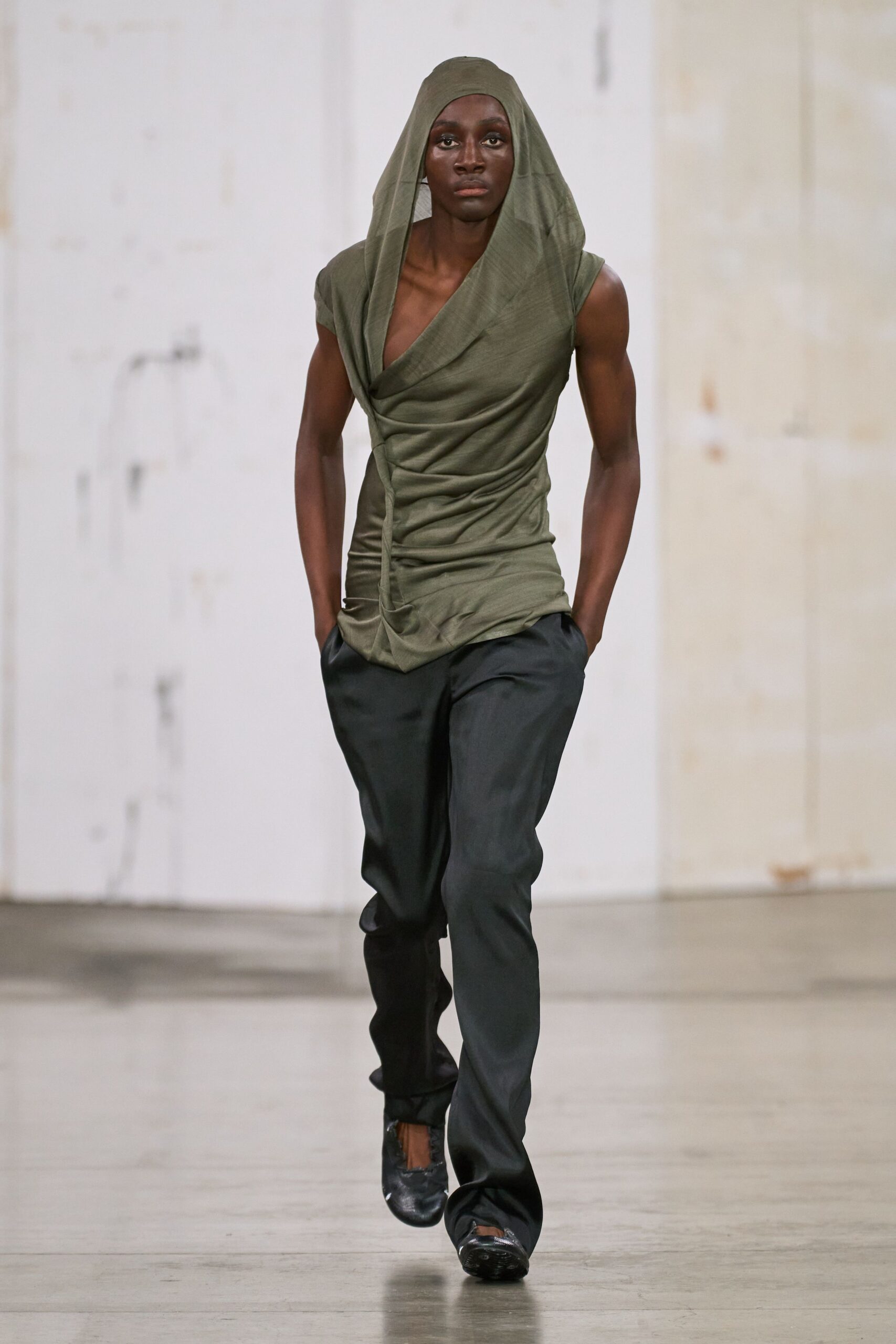 fitted green top with relaxed black pants