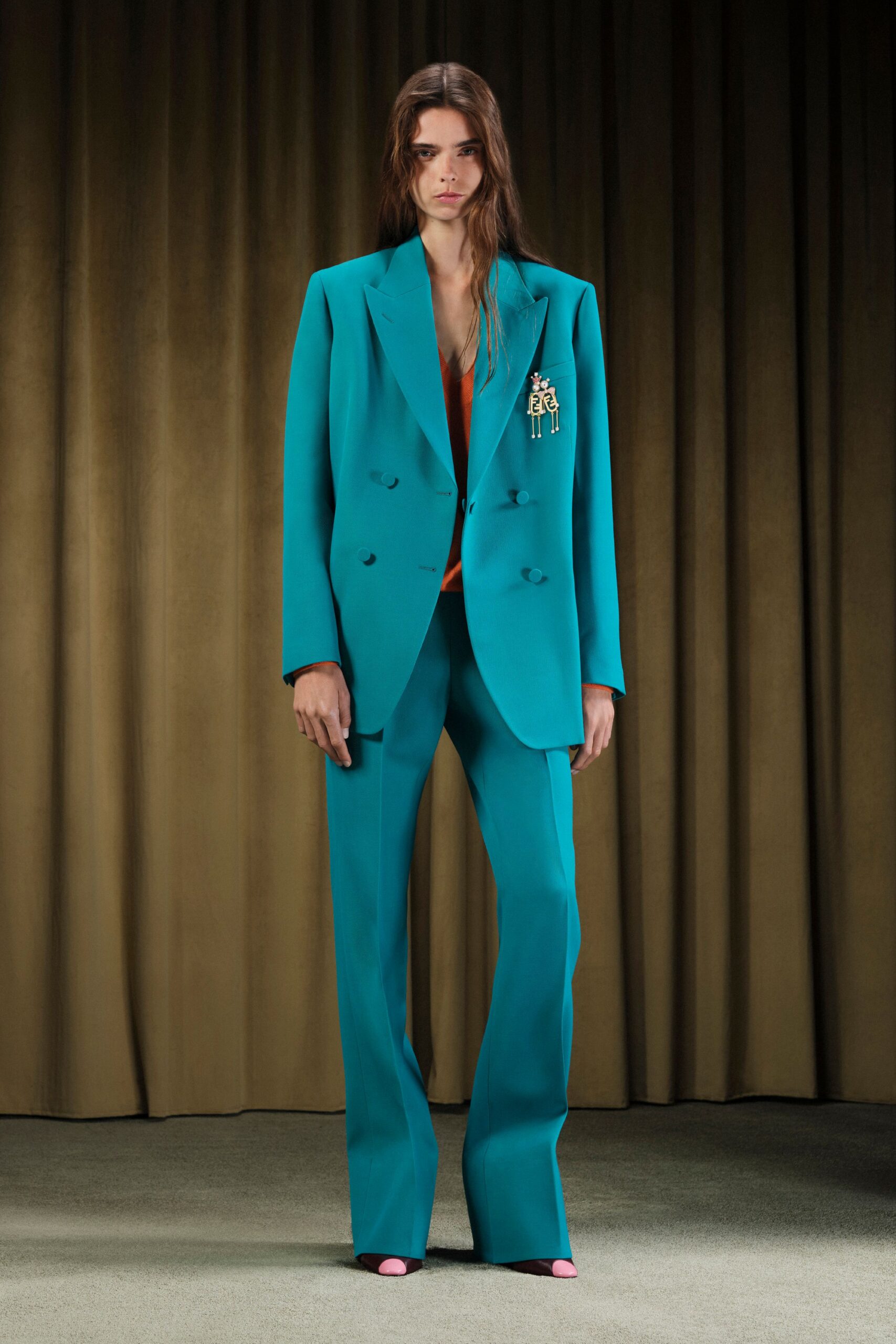 teal tailored suit with orange top