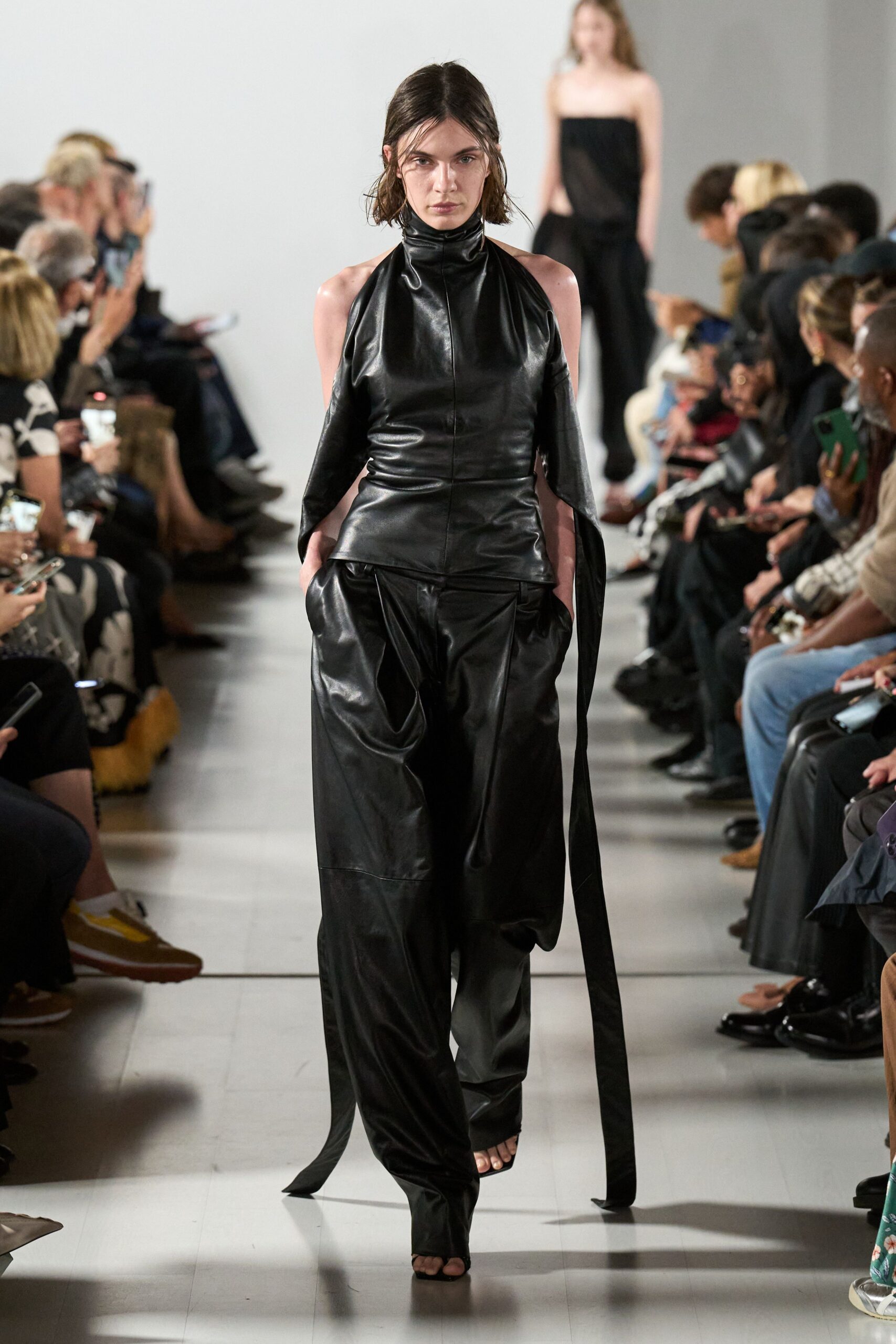 black leather sleeveless high-neck fitted zippered pockets jumpsuit