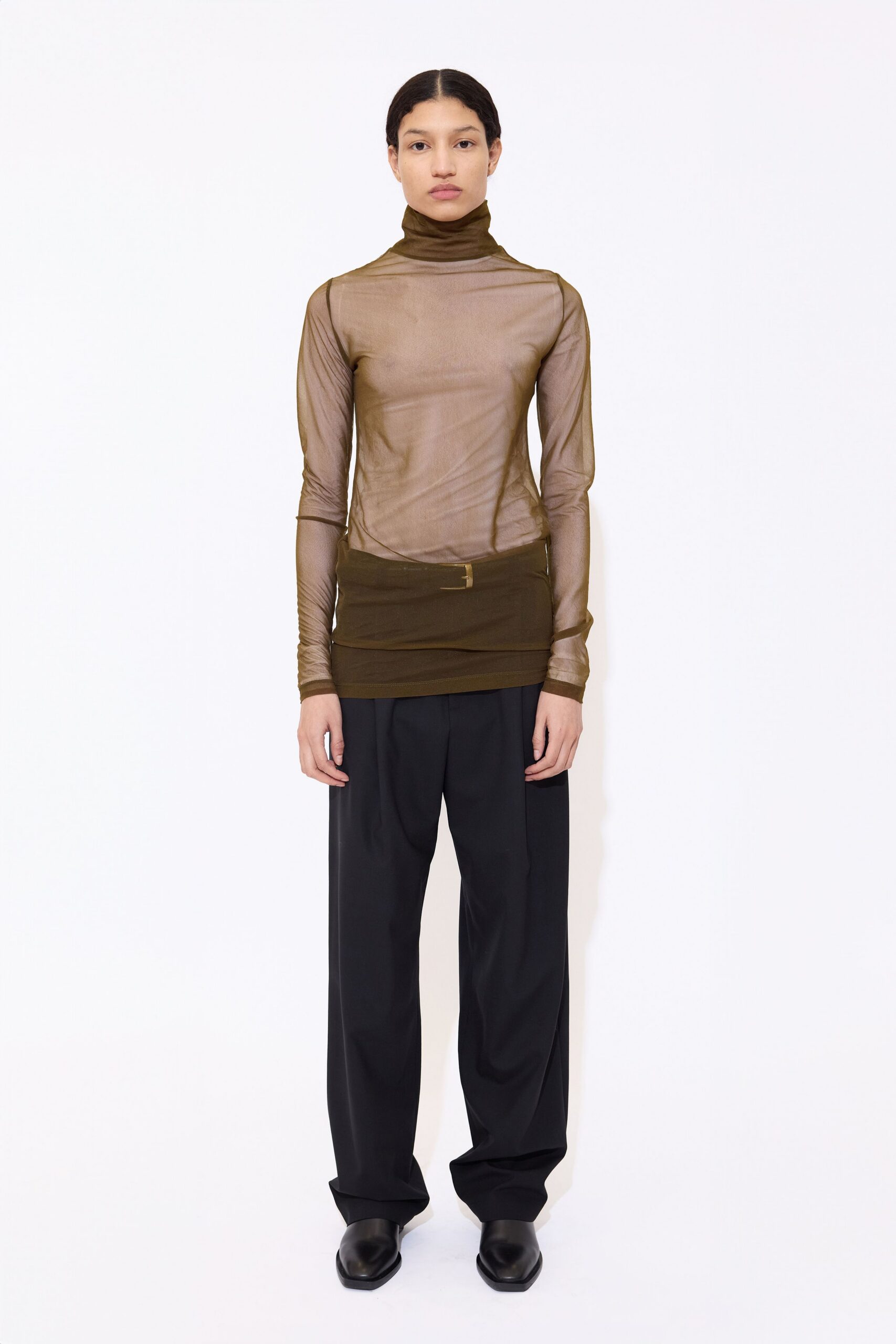 brown mesh turtleneck top with black pants