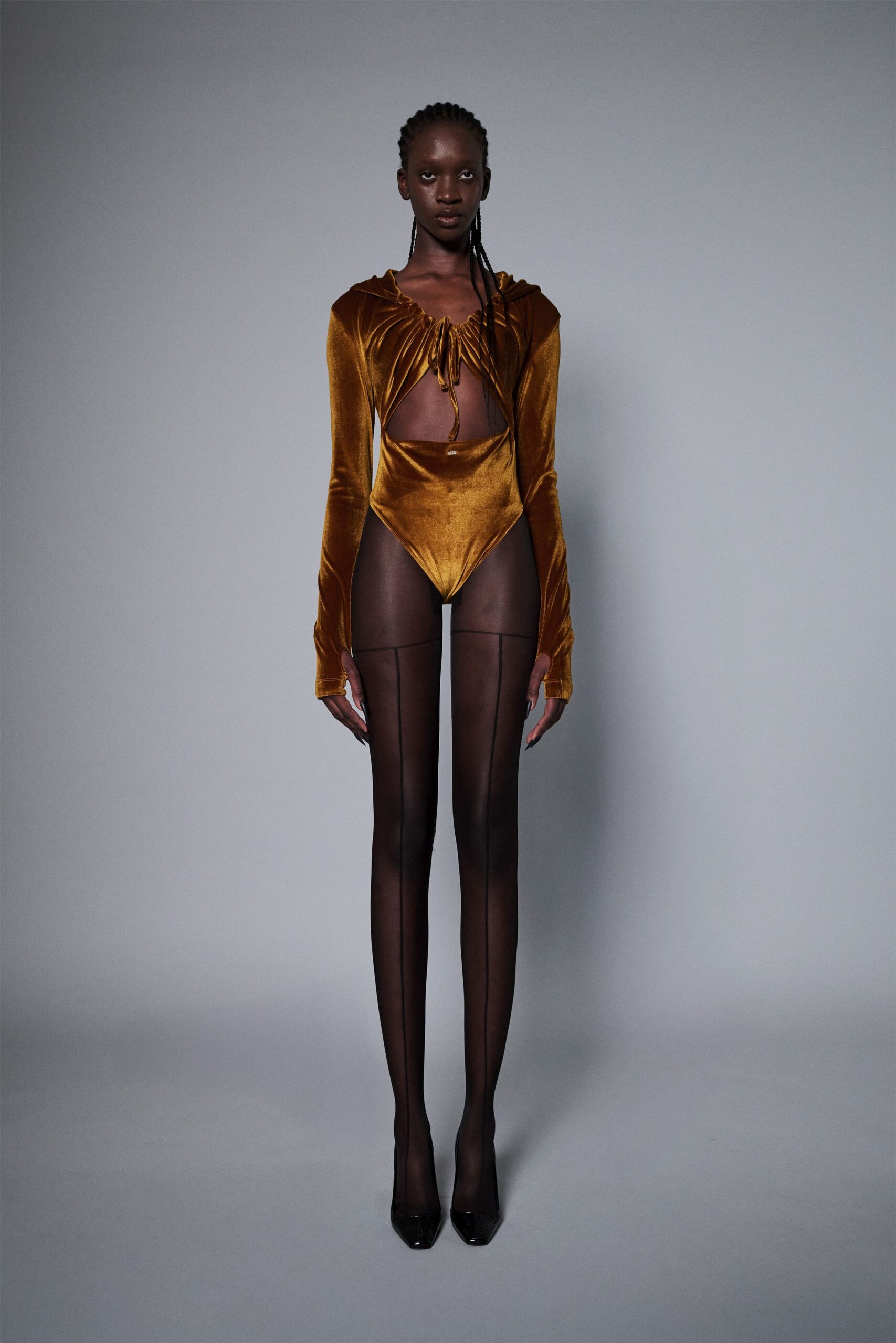 gold velvet fitted bodysuit with black shoes