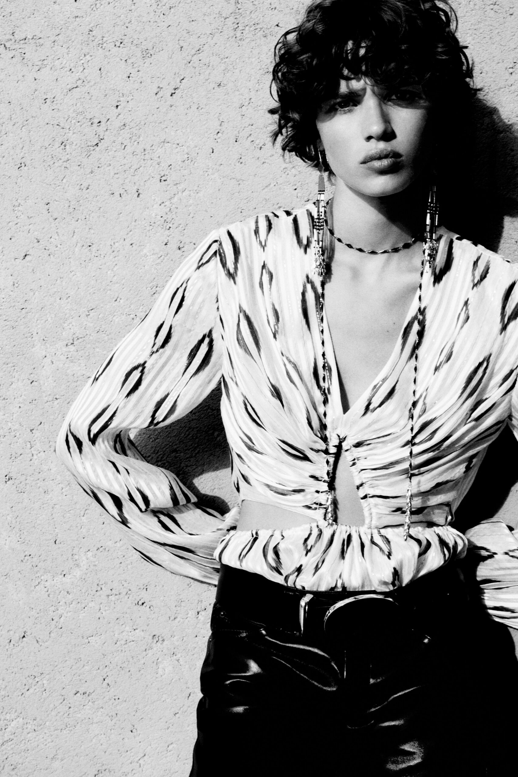 fitted black leather pants and printed top