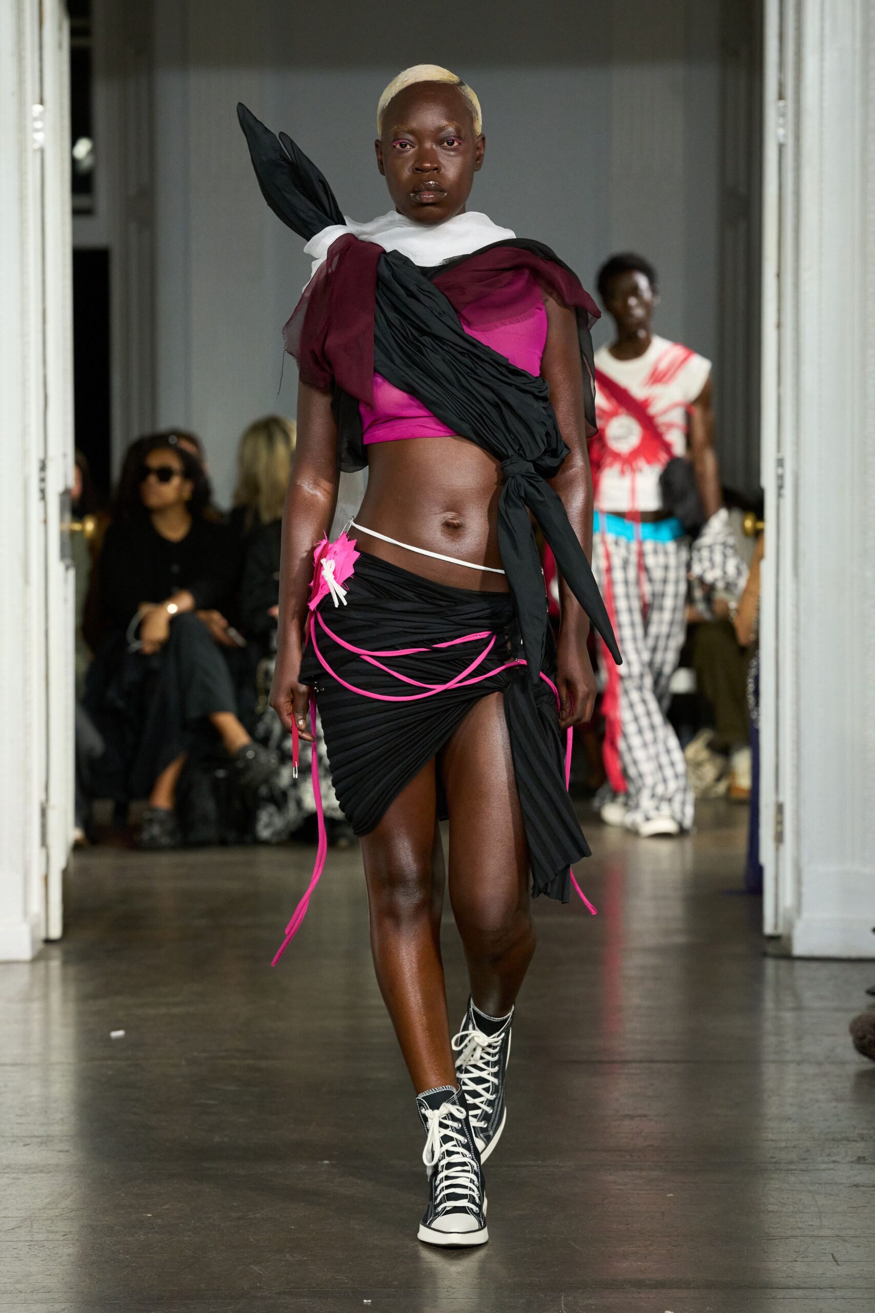 pink fitted top with asymmetric black skirt
