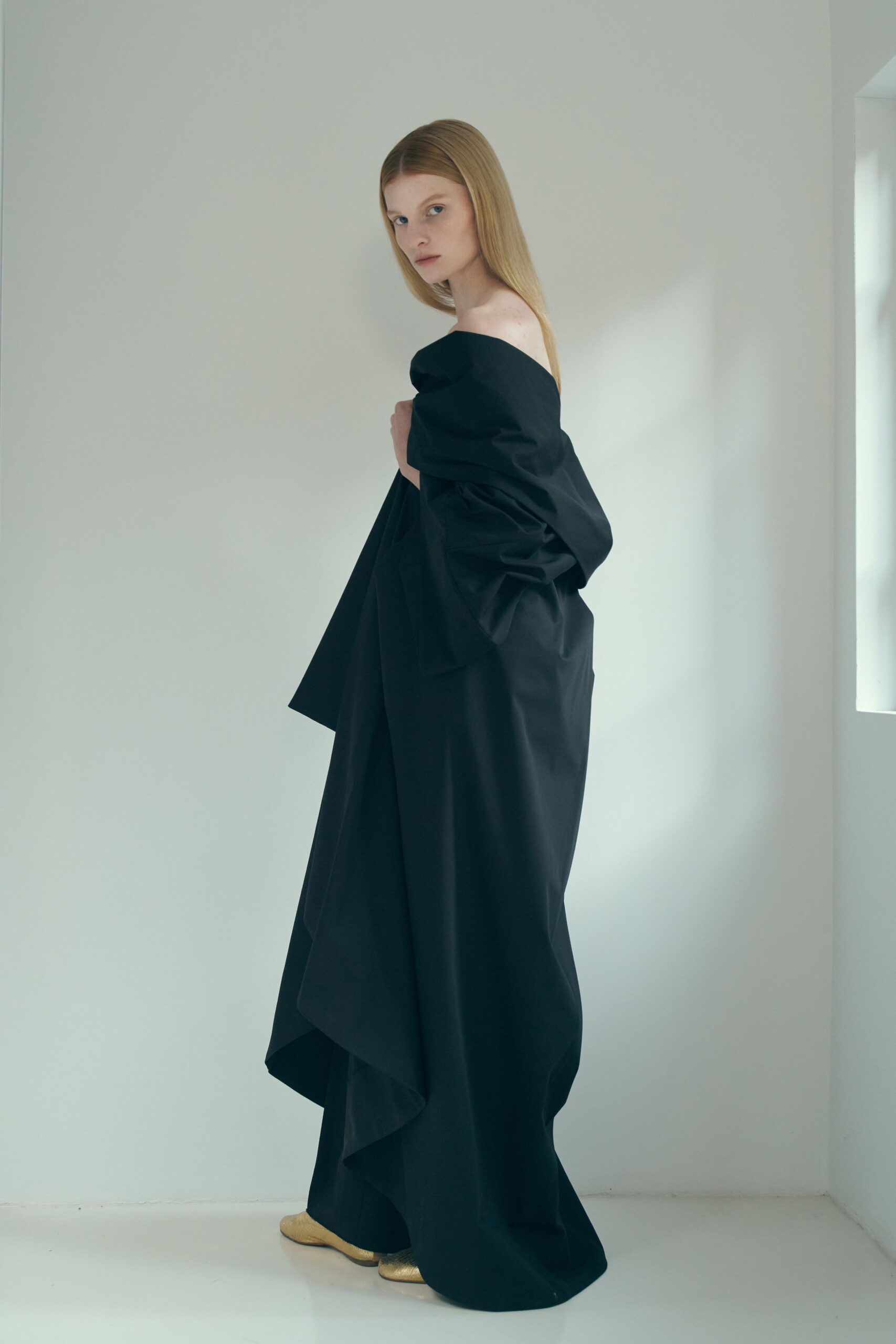 black draped maxi dress with gold shoes