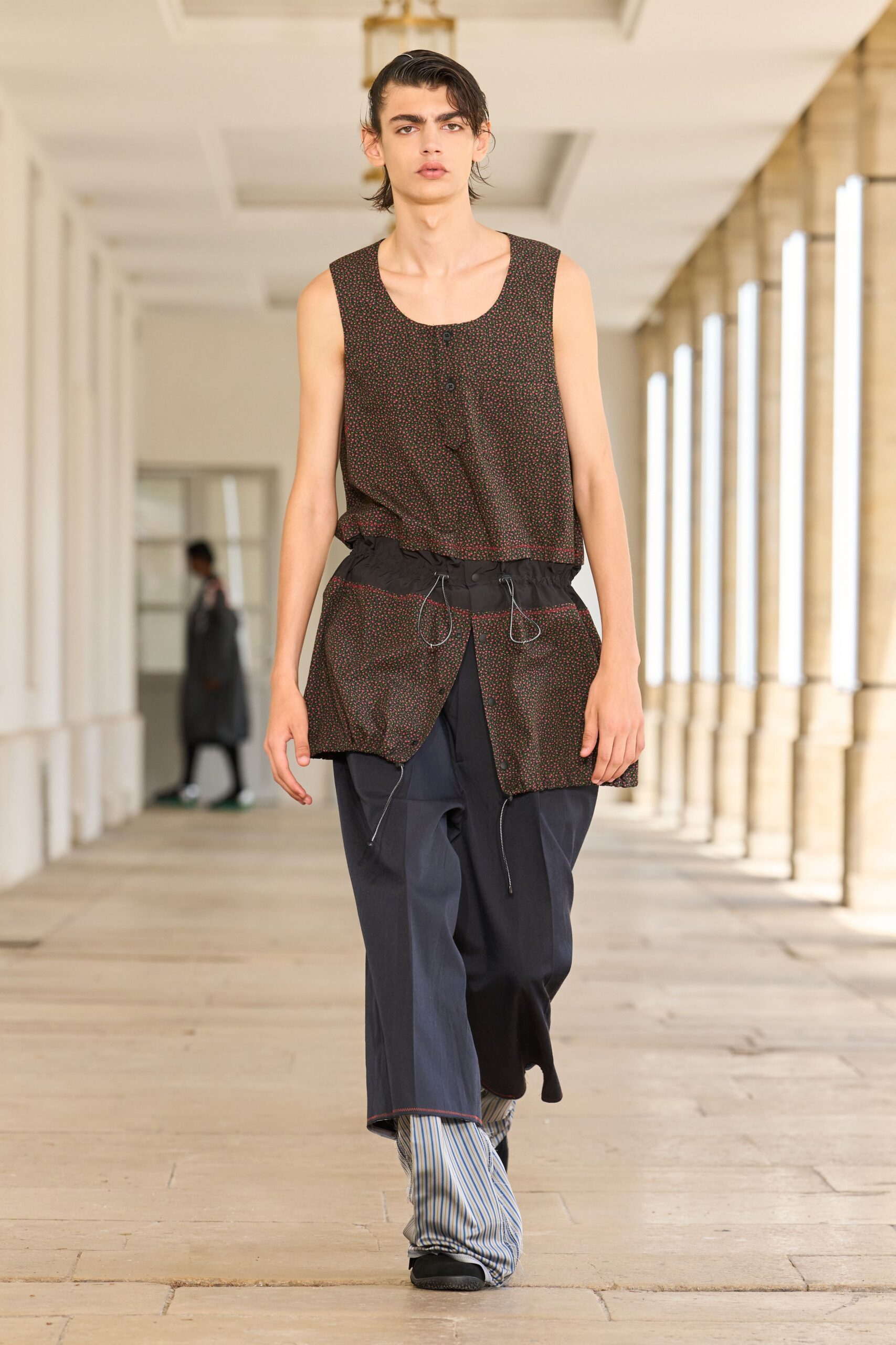 brown printed sleeveless top with blue pants