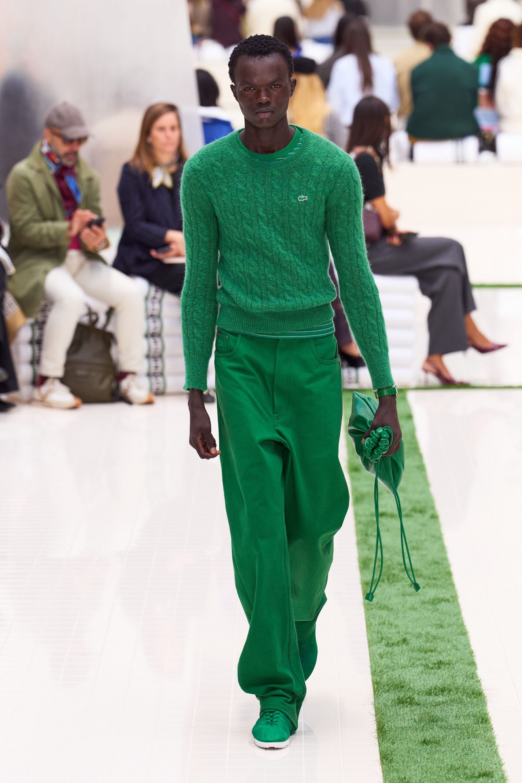green cable-knit sweater and wide-leg pants
