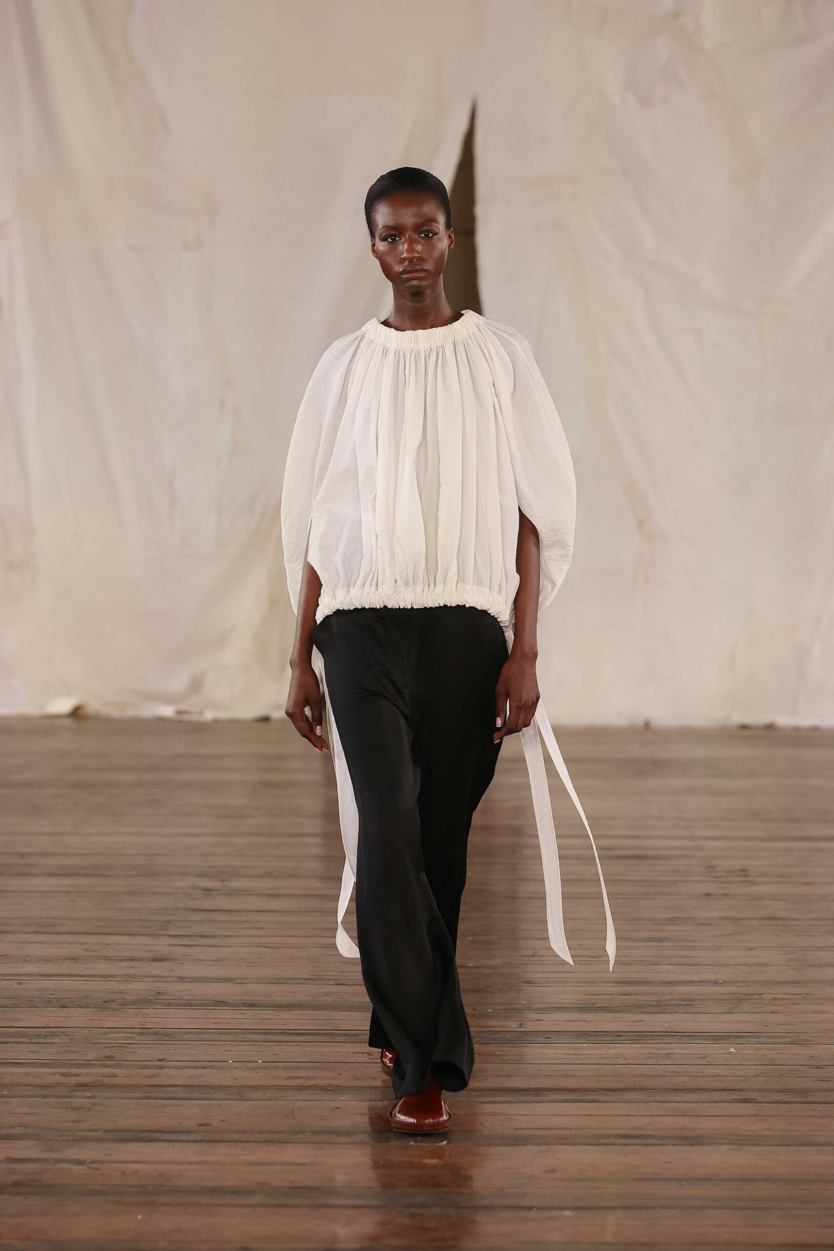 white relaxed top with black pants
