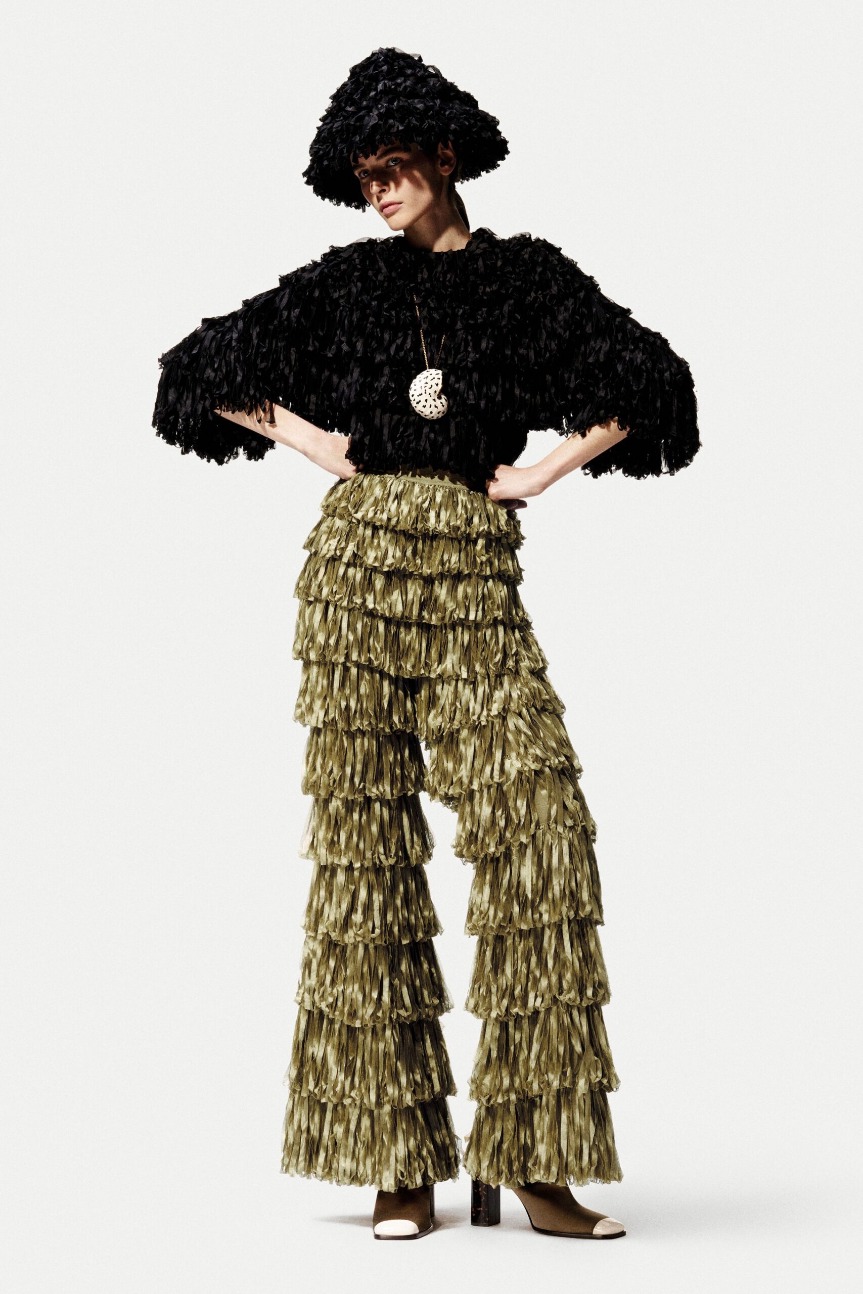 black fringed top green tiered pants