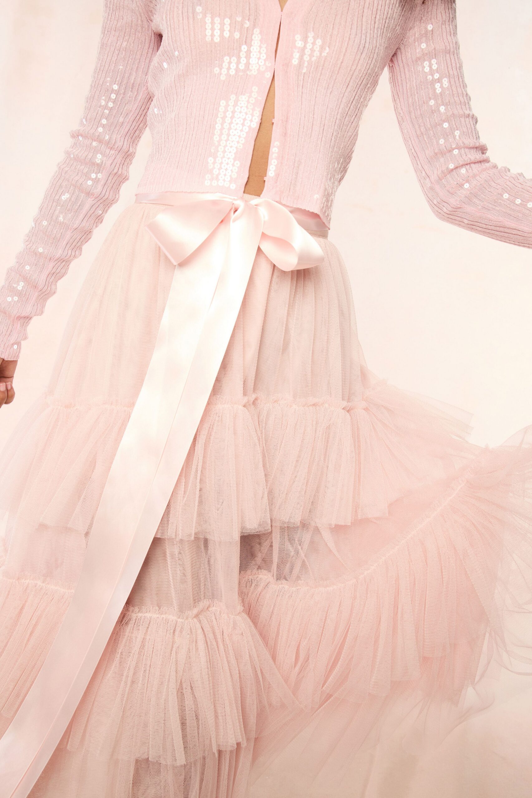 pink sequined cardigan with tiered dress