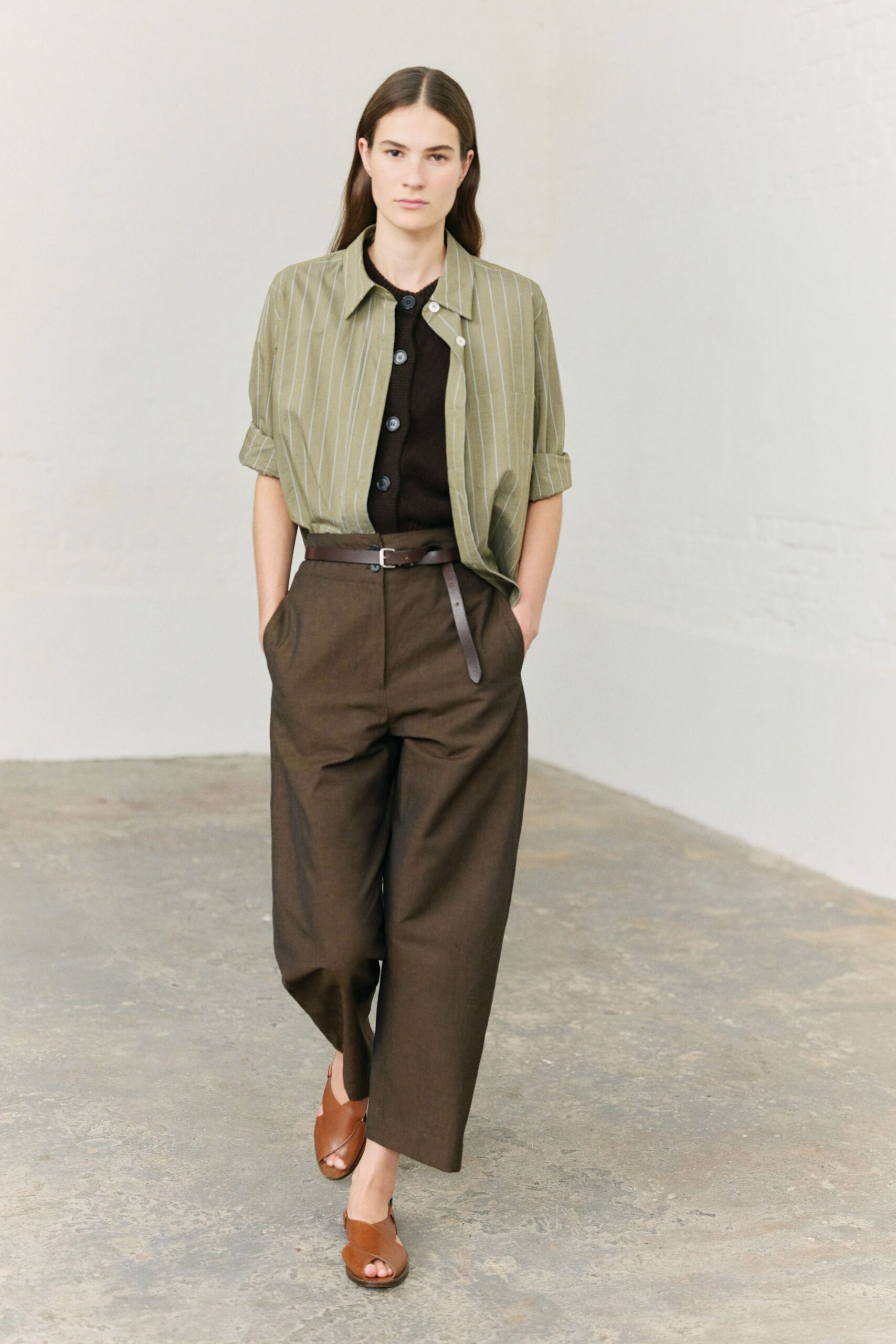 green striped shirt black top brown pants