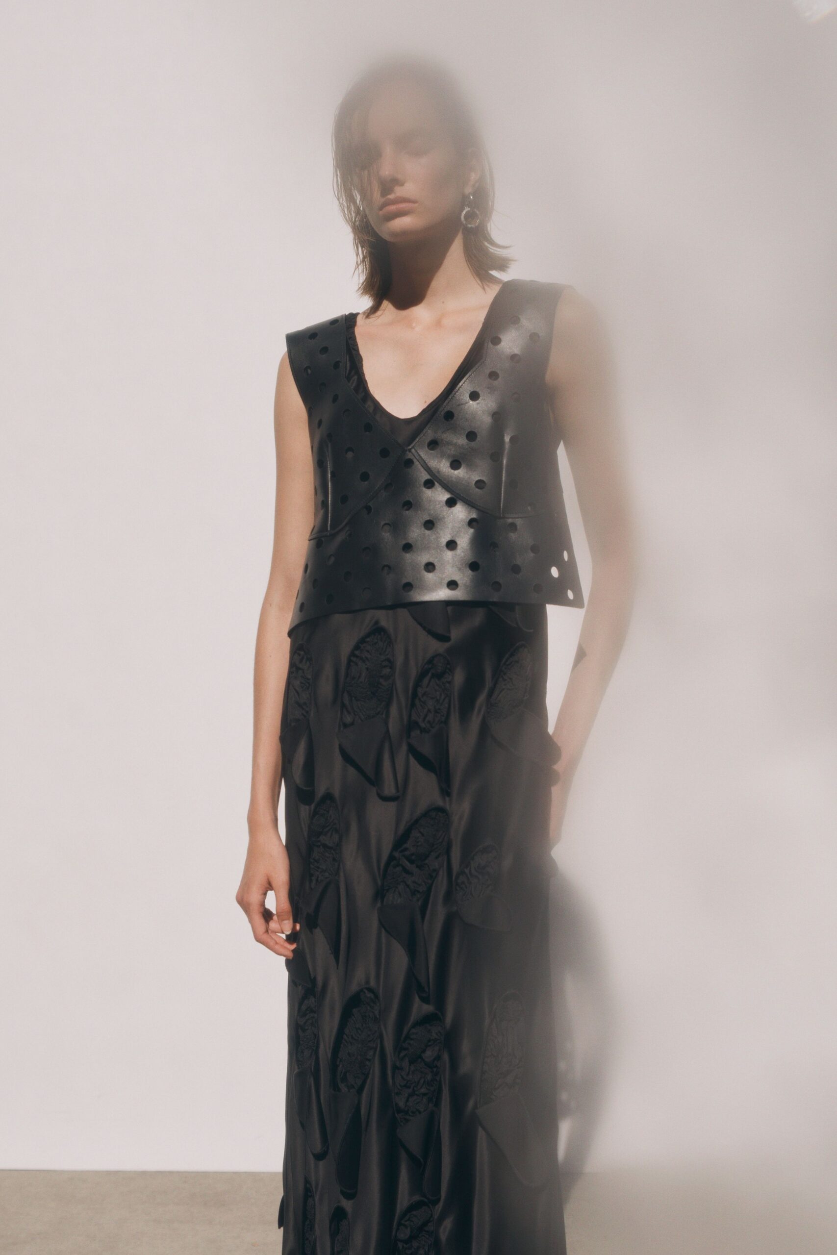 black leather sleeveless v-neck fitted embellished top