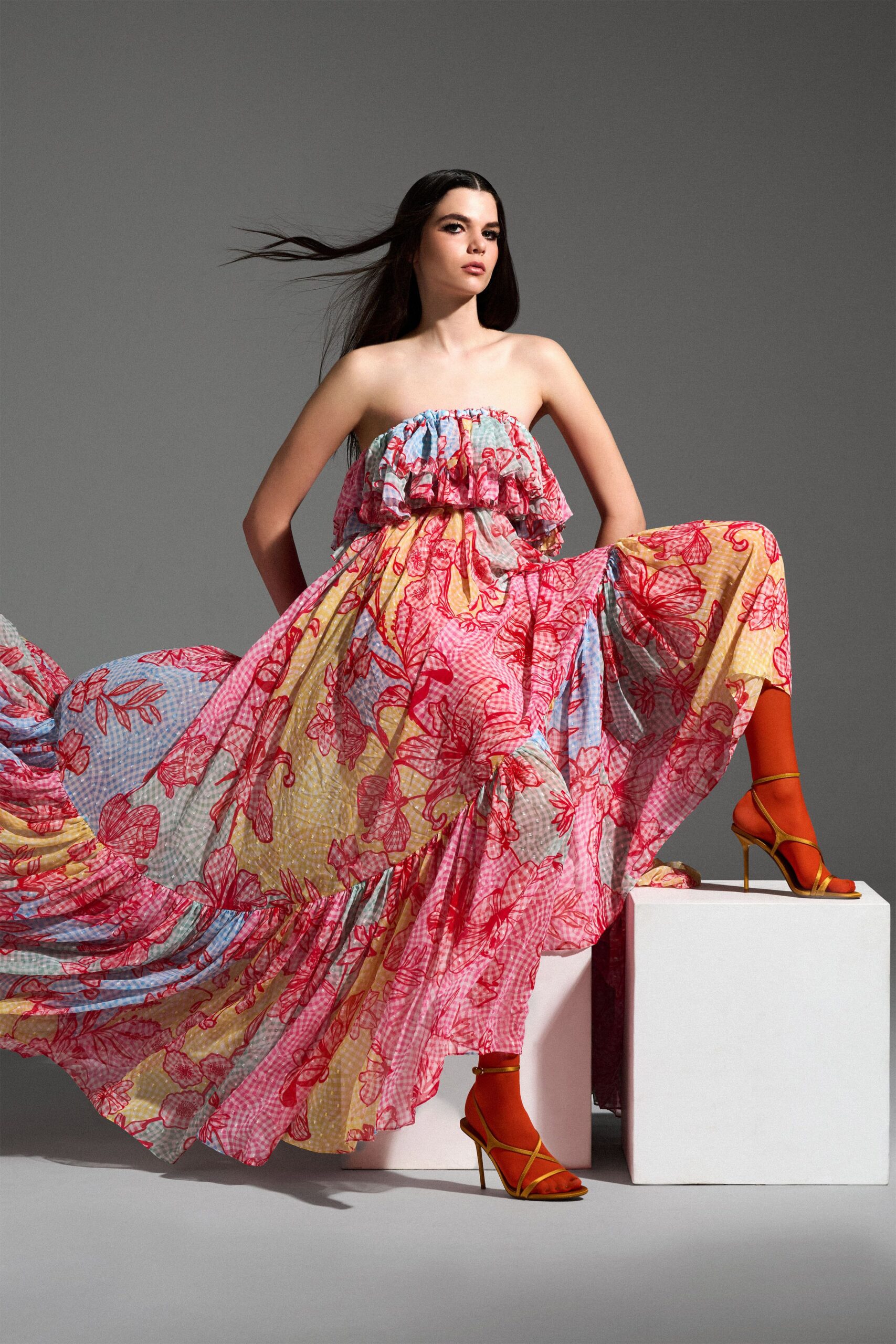 red cotton strapless fitted floral tiered flowing gown