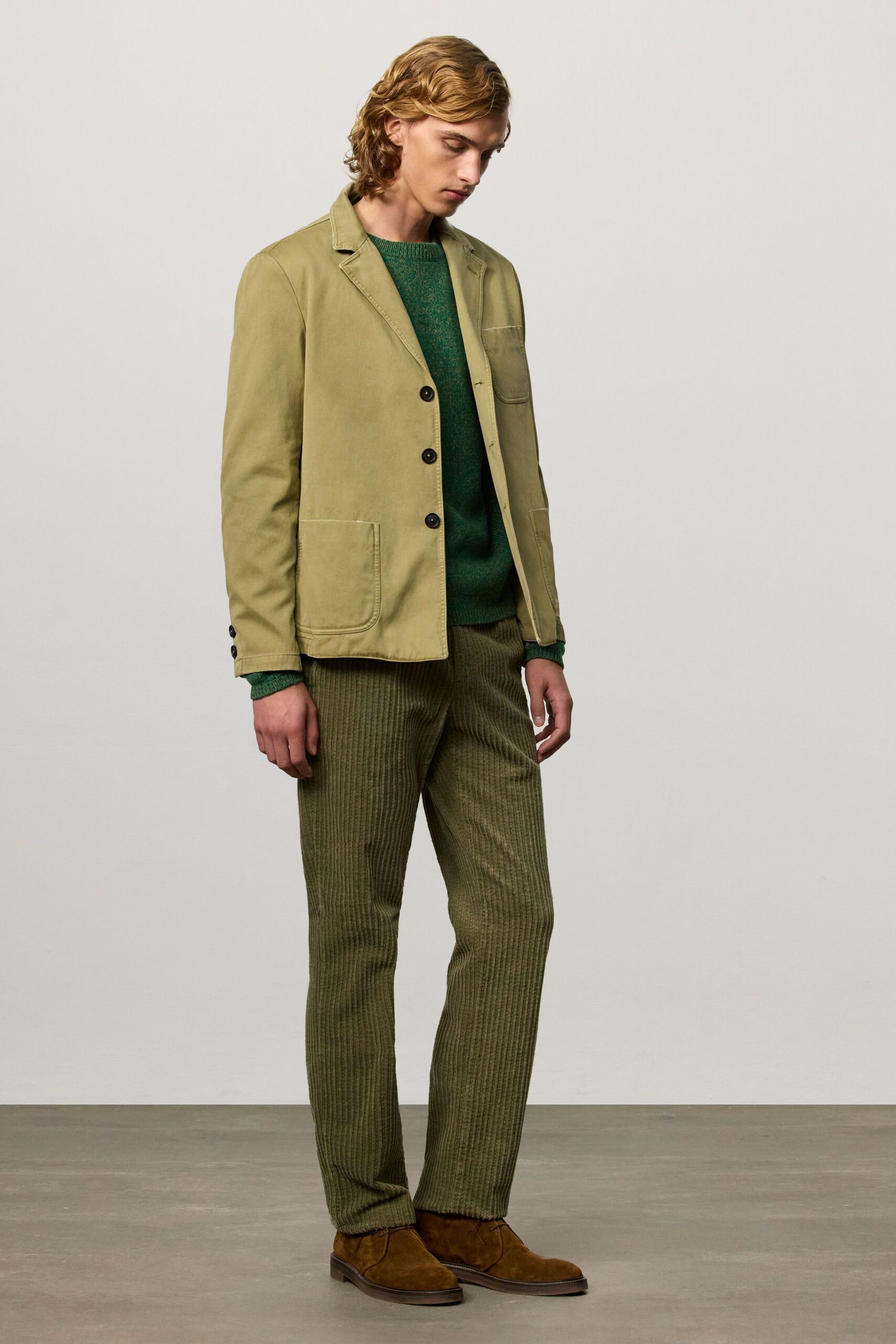 beige blazer green sweater striped pants