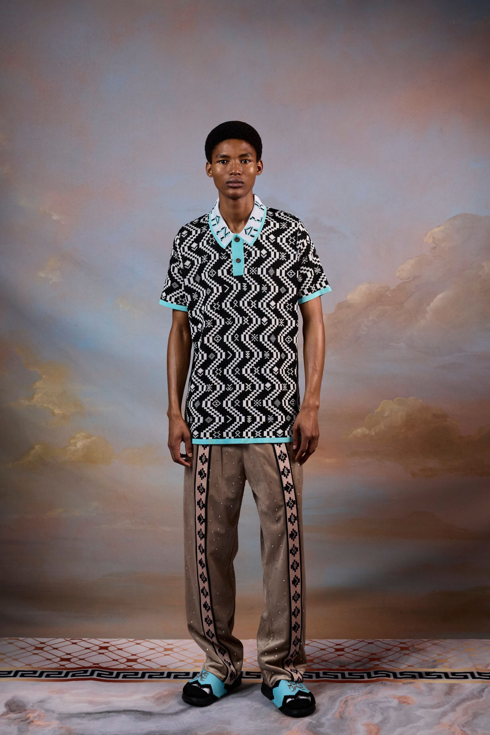 black and white printed shirt with beige pants