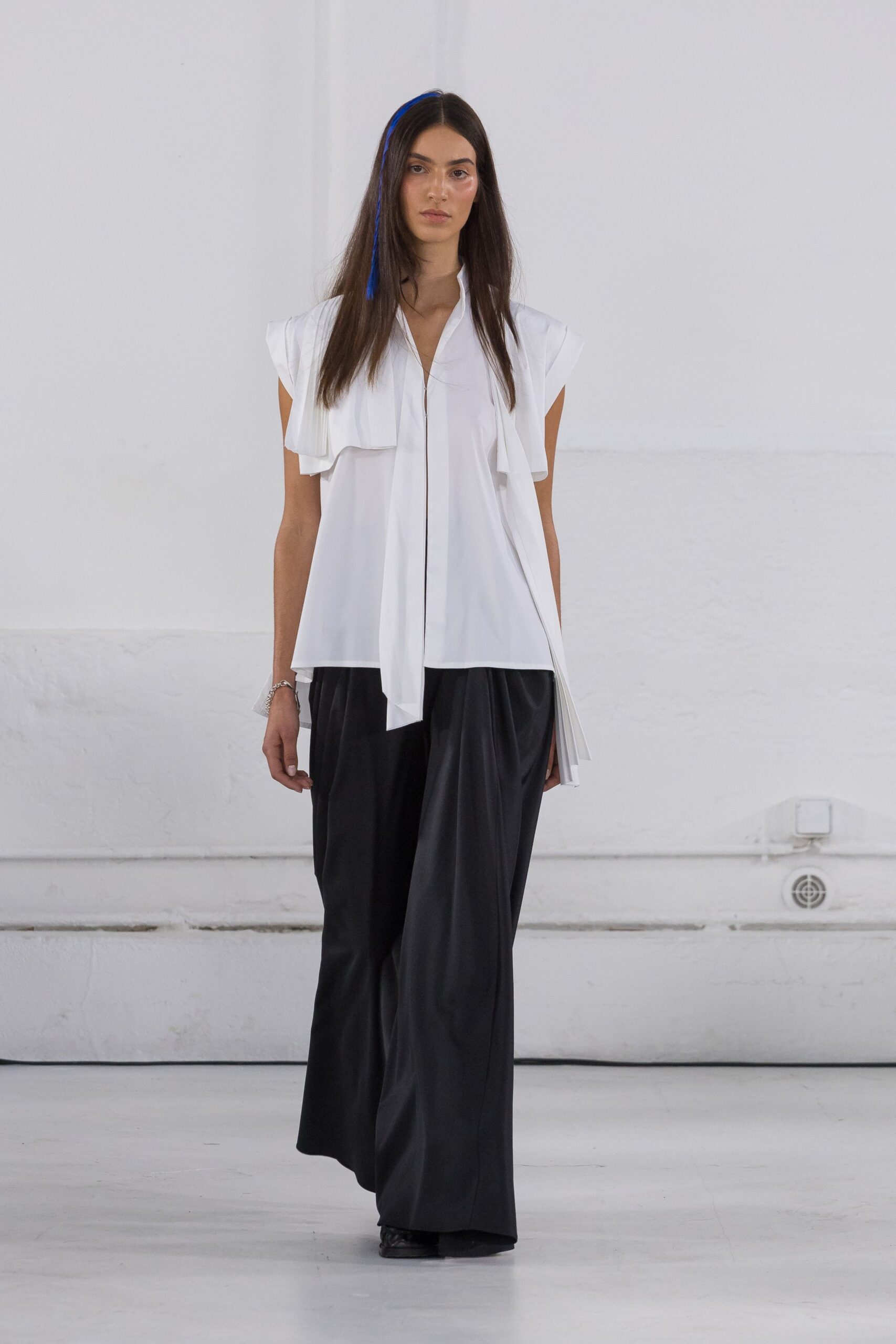 white relaxed top with black pants