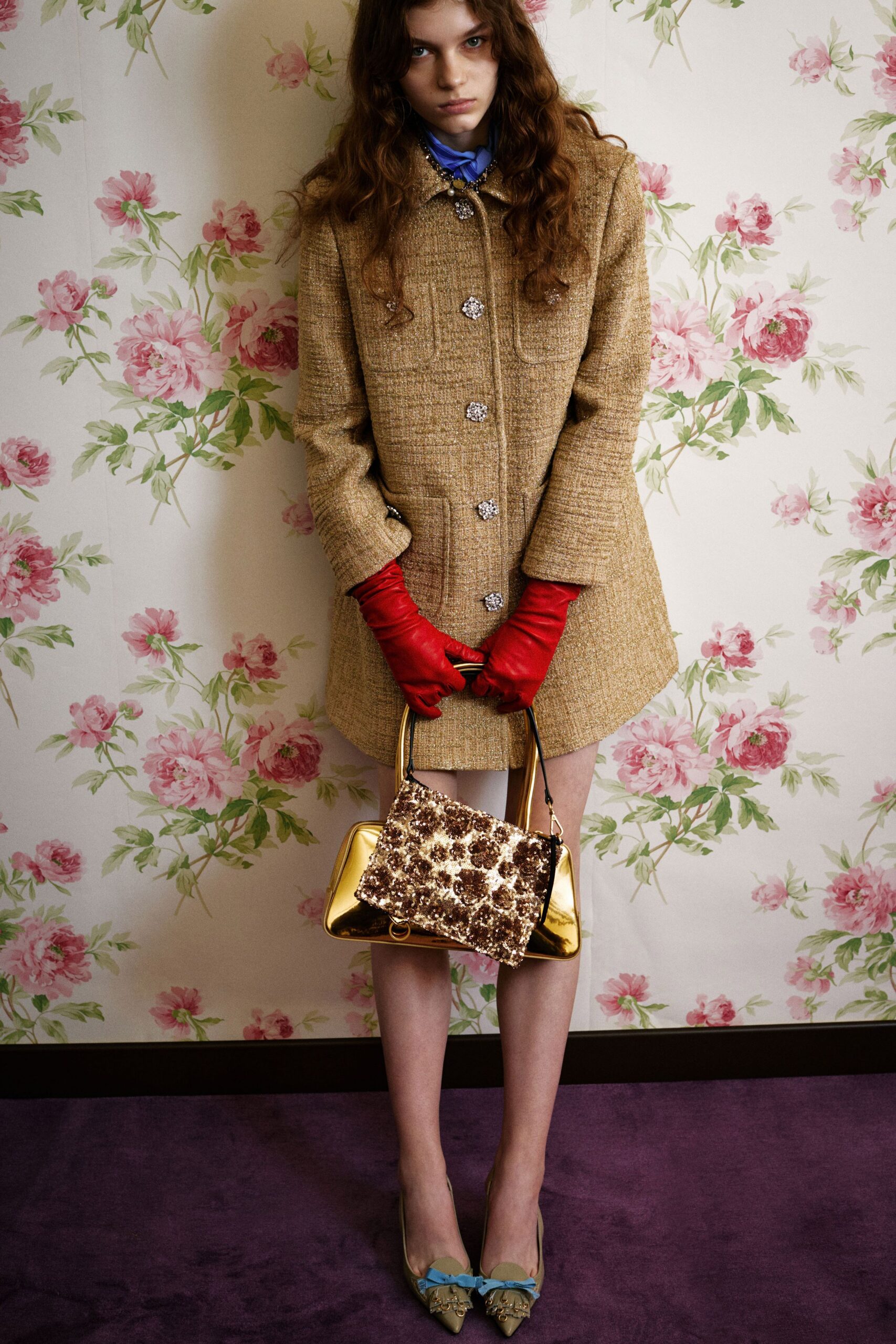 beige tweed coat with red gloves
