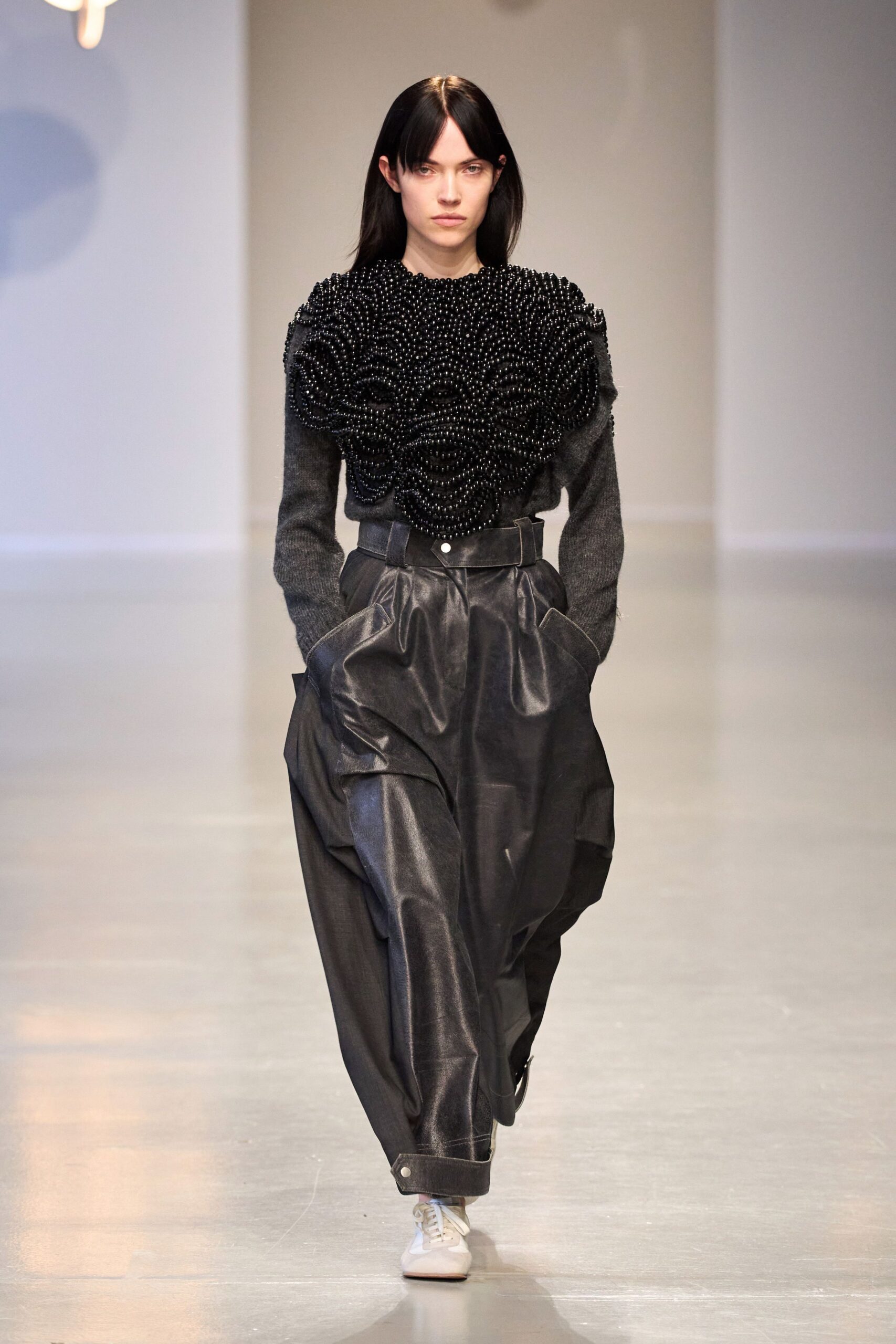 black beaded top and relaxed pants