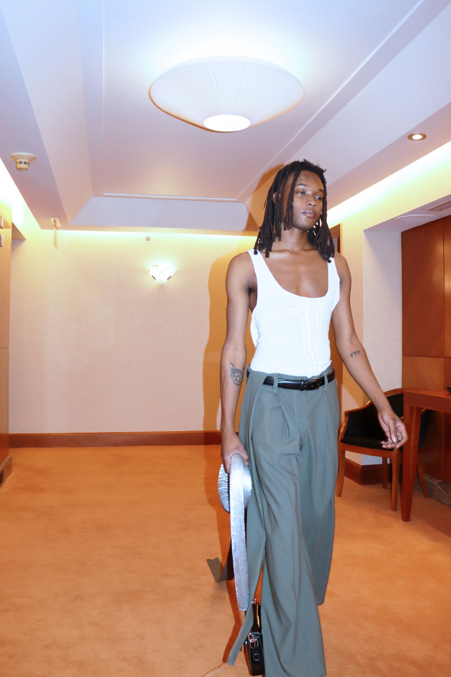 white fitted bodysuit and green pants