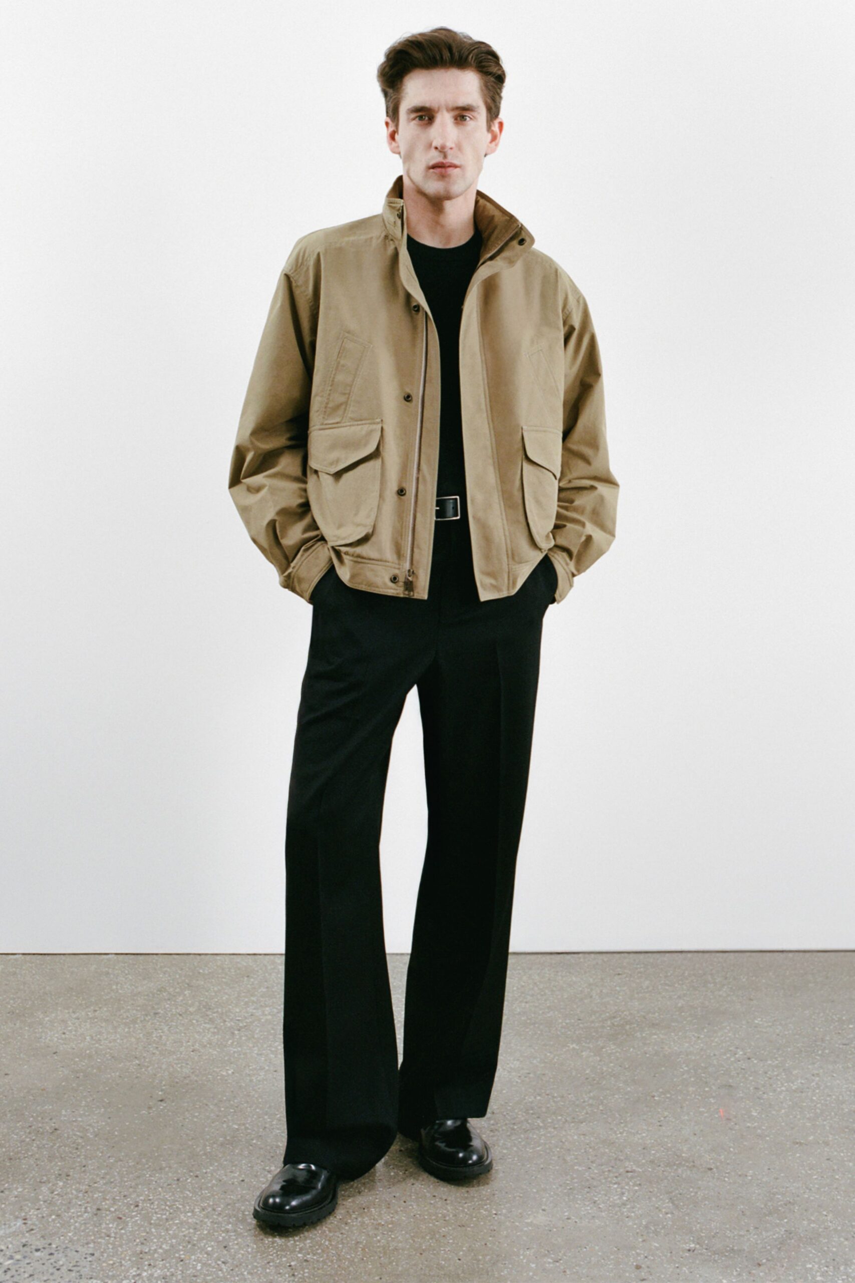beige jacket black shirt tailored pants