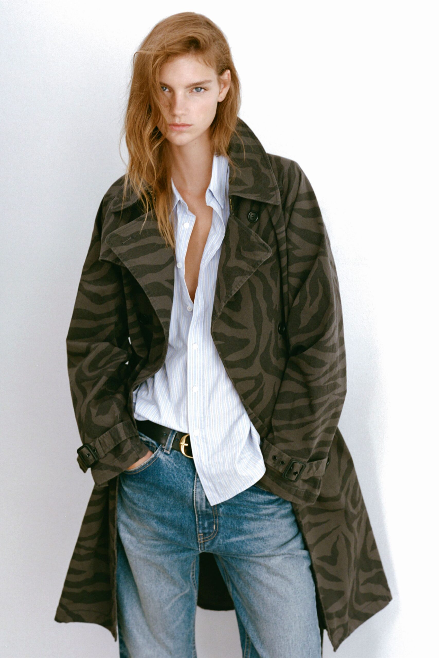 black printed trench coat with shirt and jeans