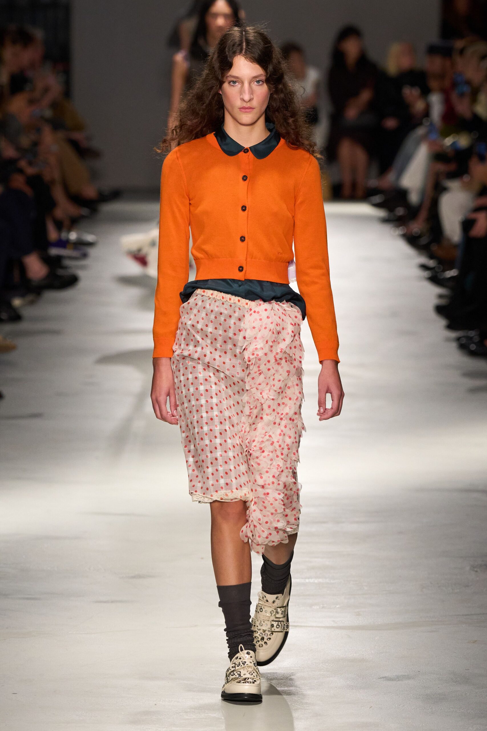 orange cardigan pink polka-dot skirt