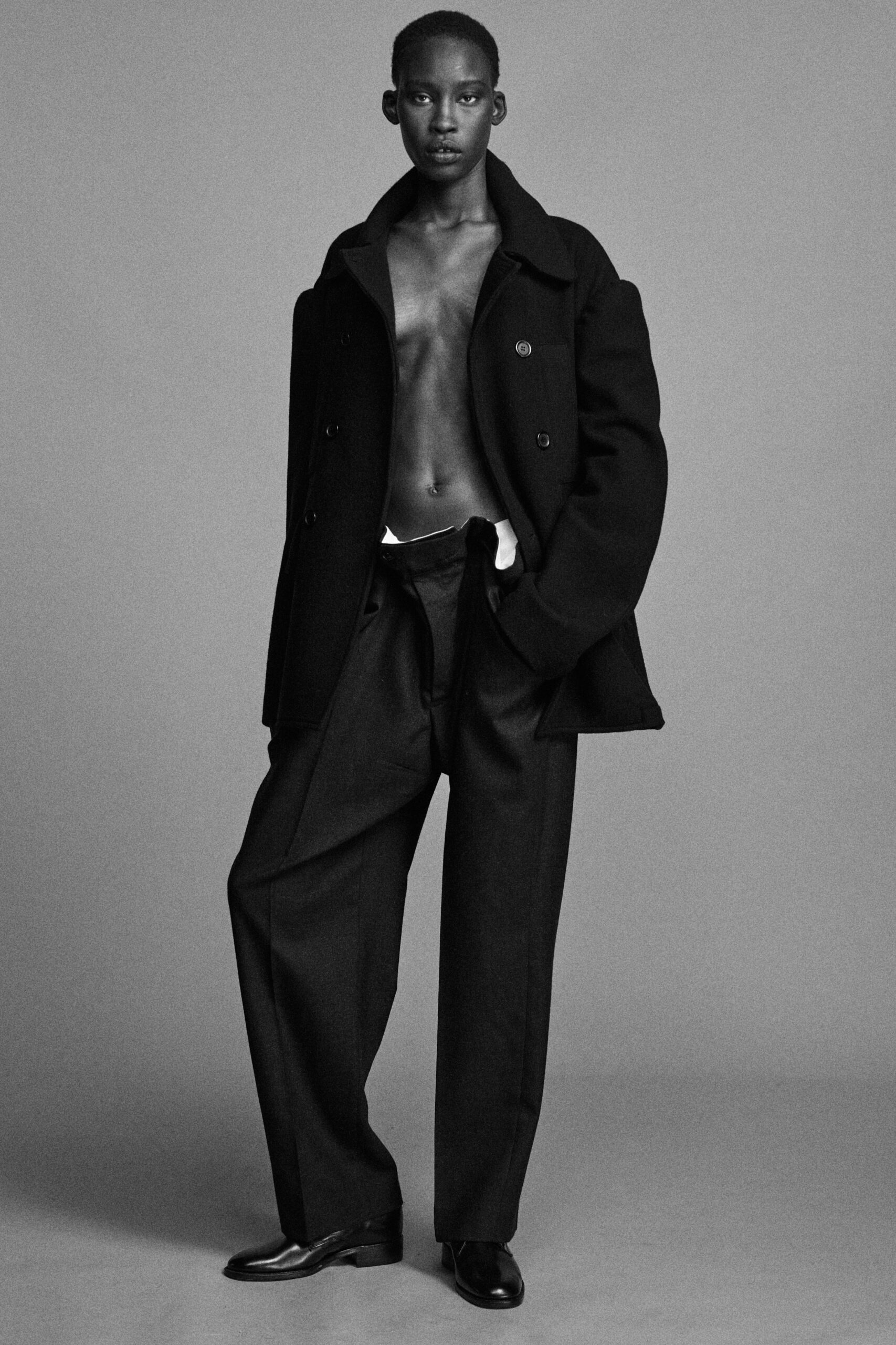 black wool coat with relaxed pants