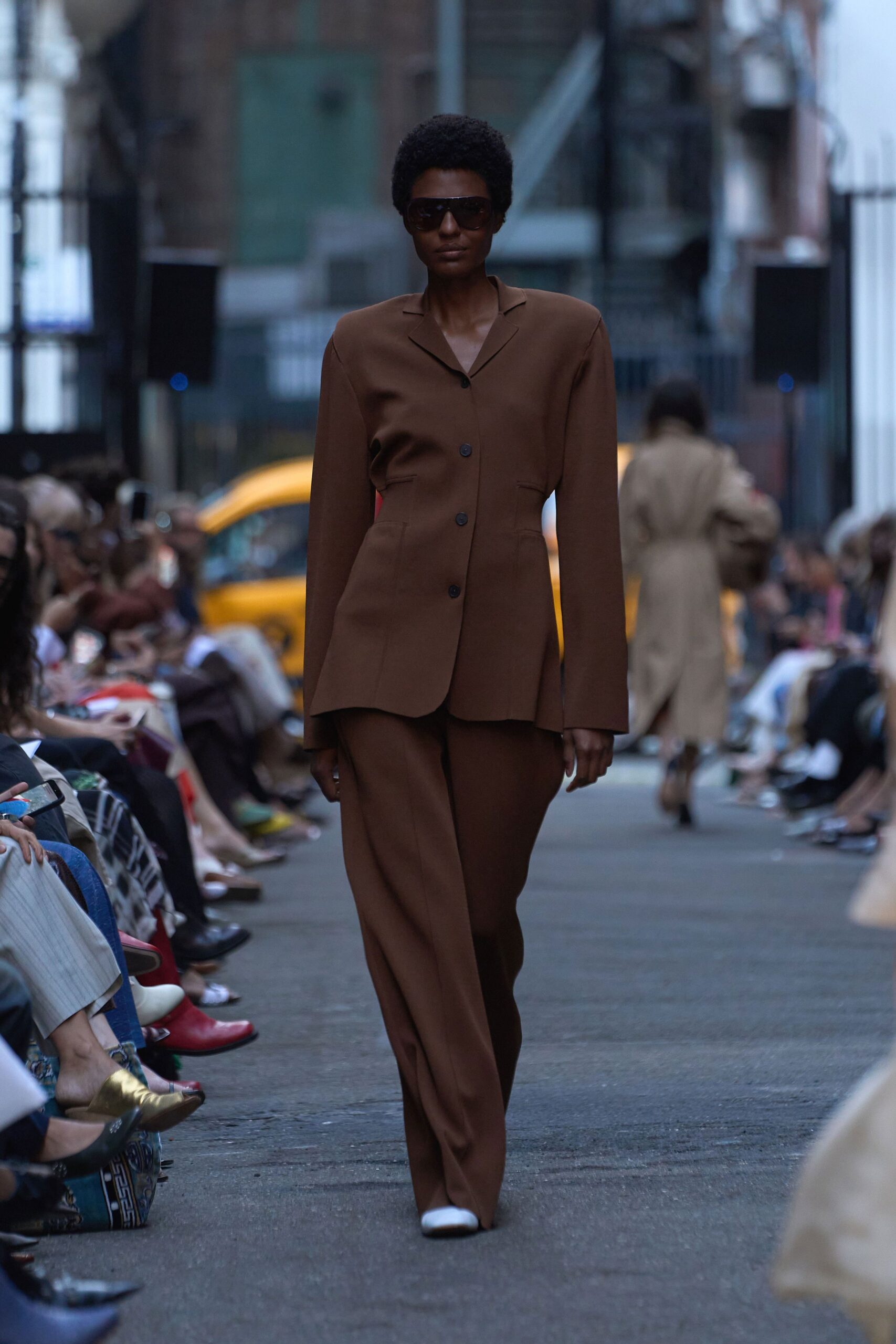 brown tailored suit with sunglasses