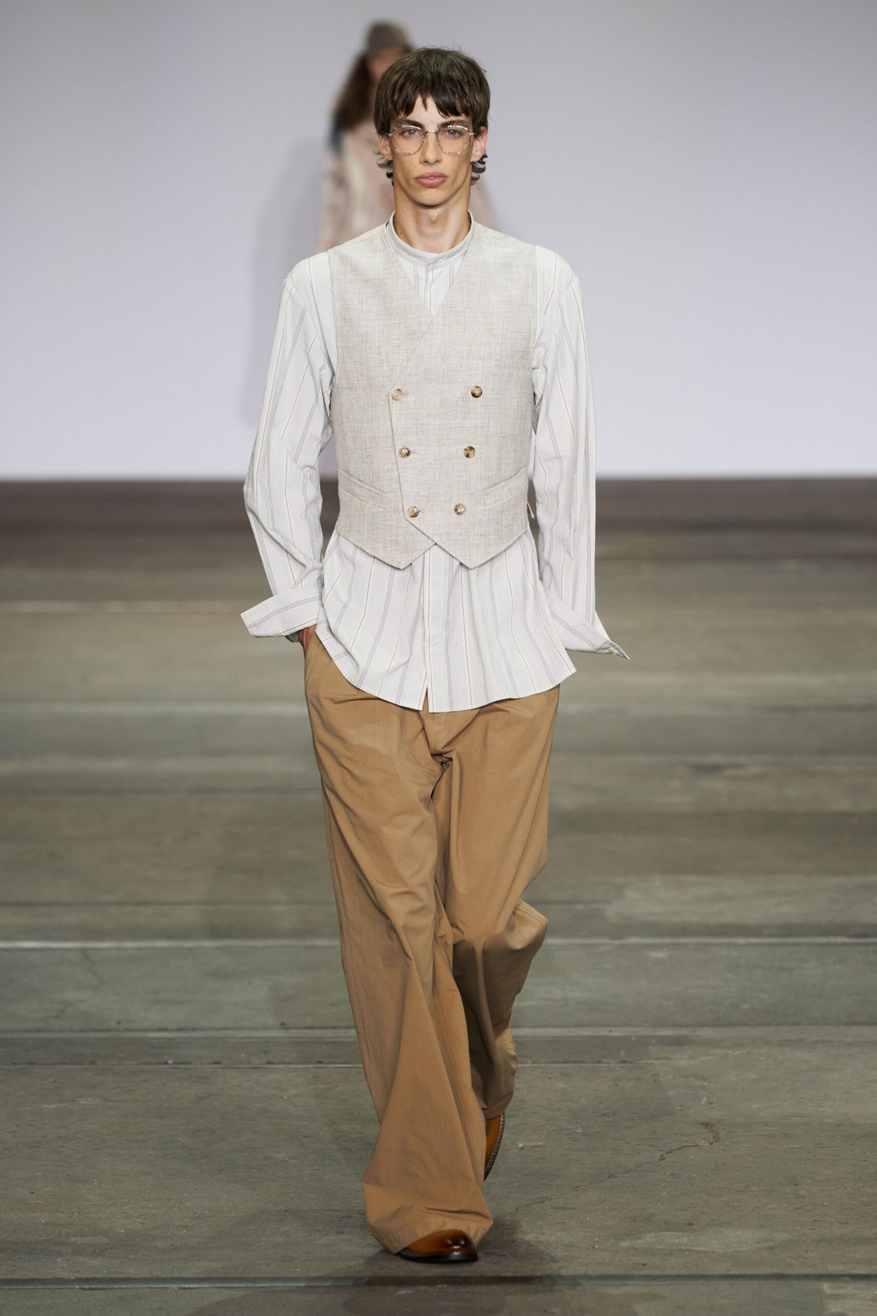 beige vest with relaxed shirt and brown pants