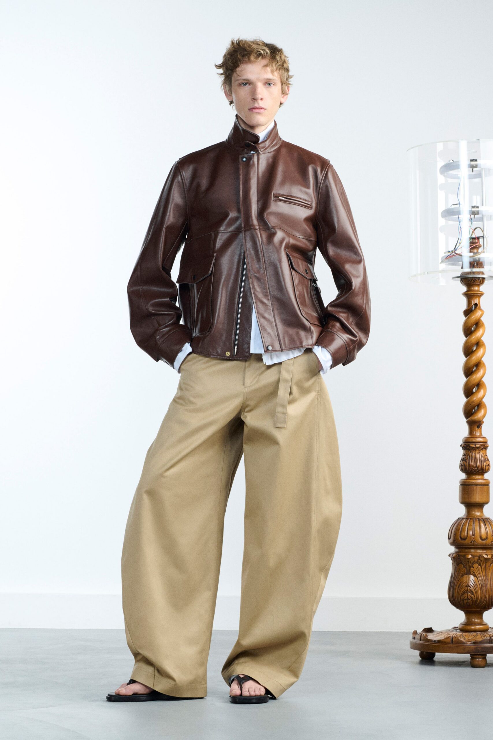 brown leather relaxed jacket with beige wide-leg pants