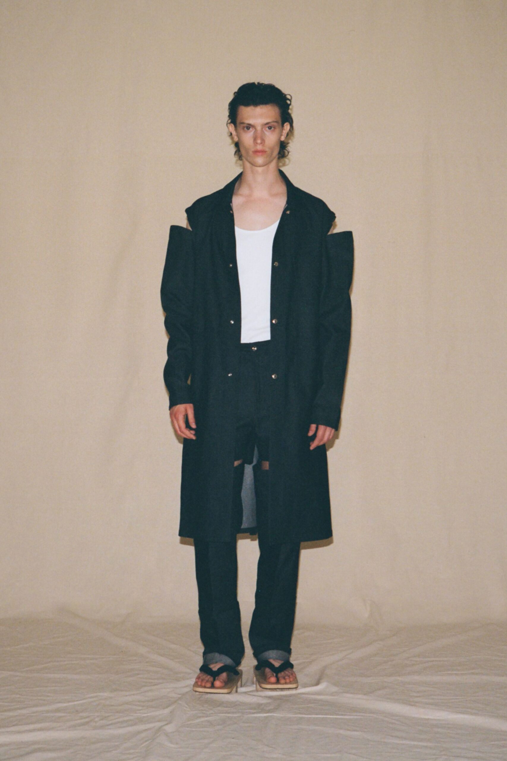black coat white top black pants sandals