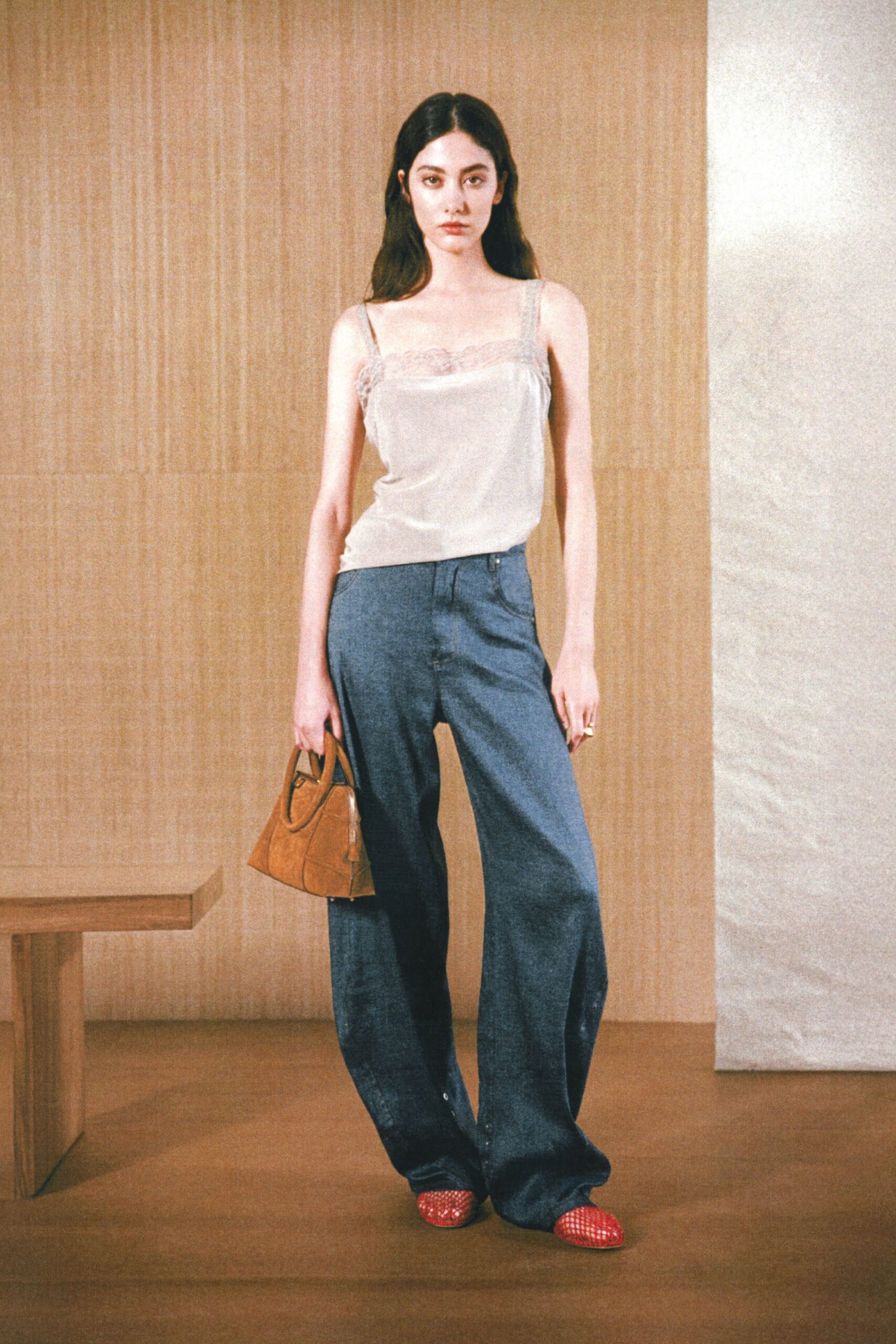 white silk sleeveless top with blue denim pants