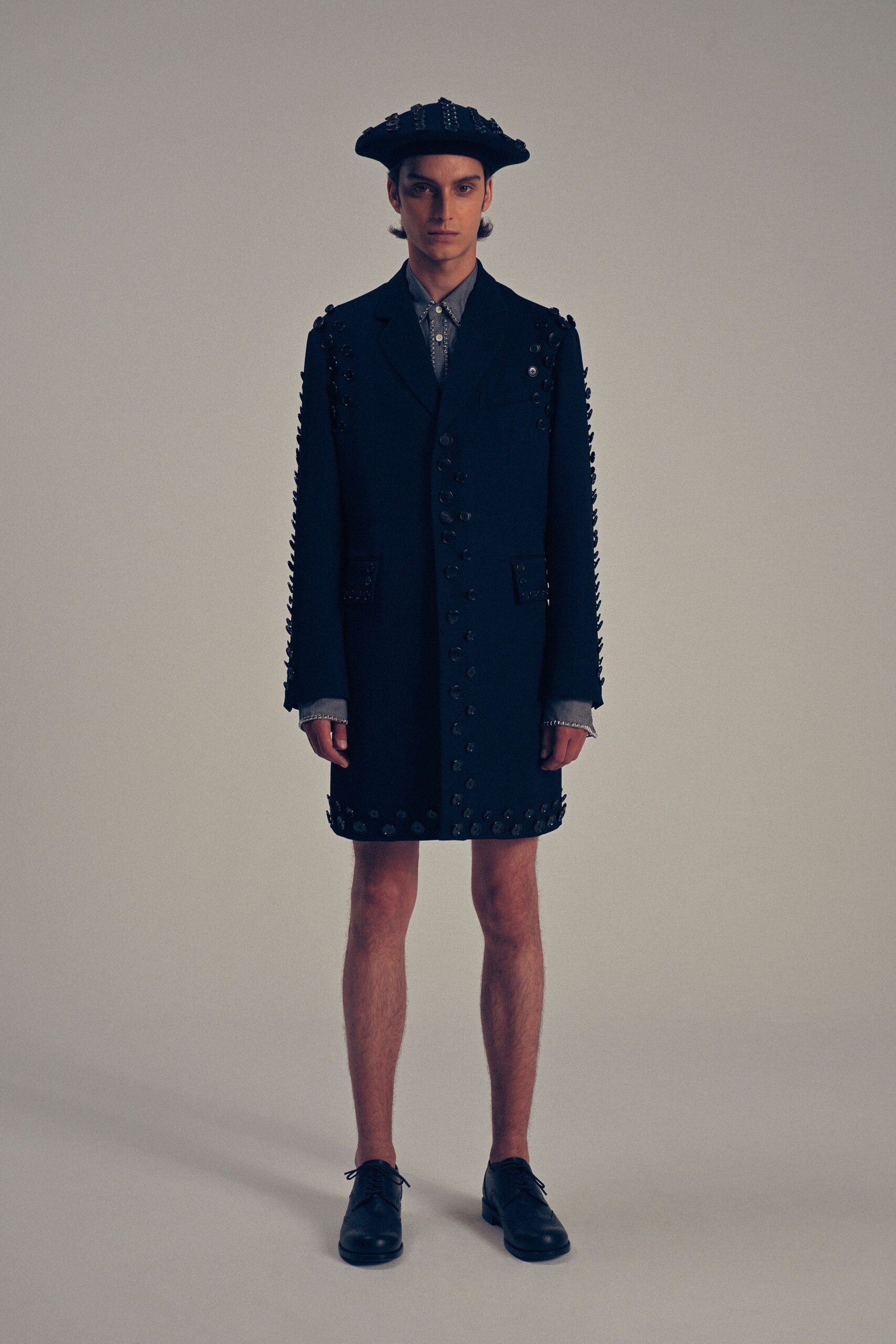 black embellished coat with gray shirt
