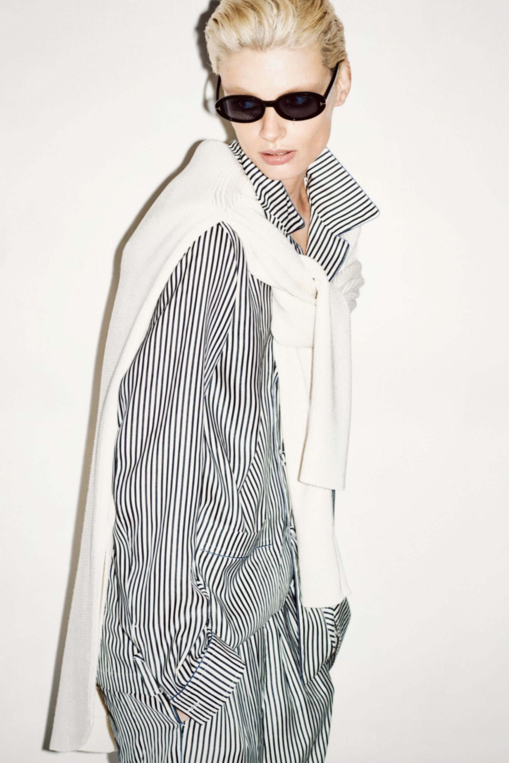 striped shirt with white sweater