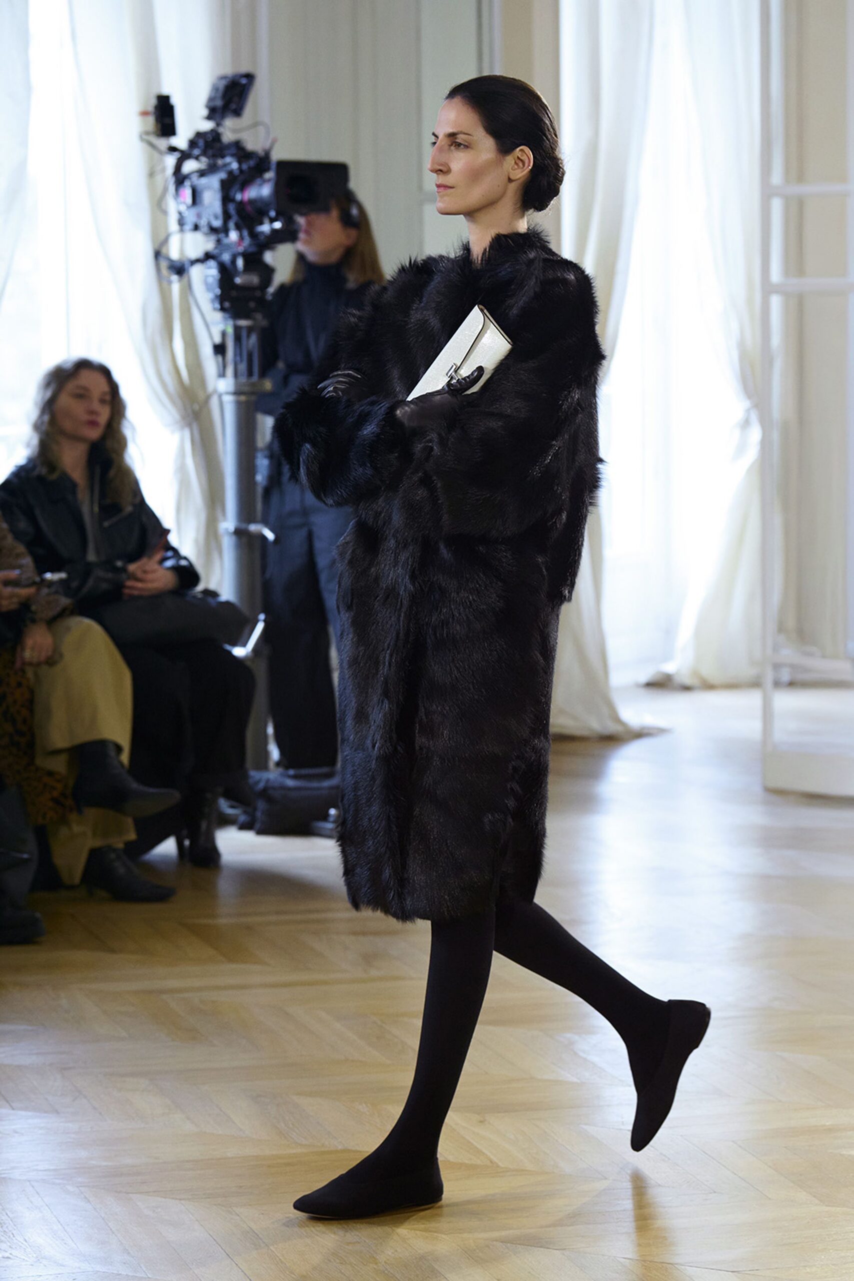 black fur coat with white bag
