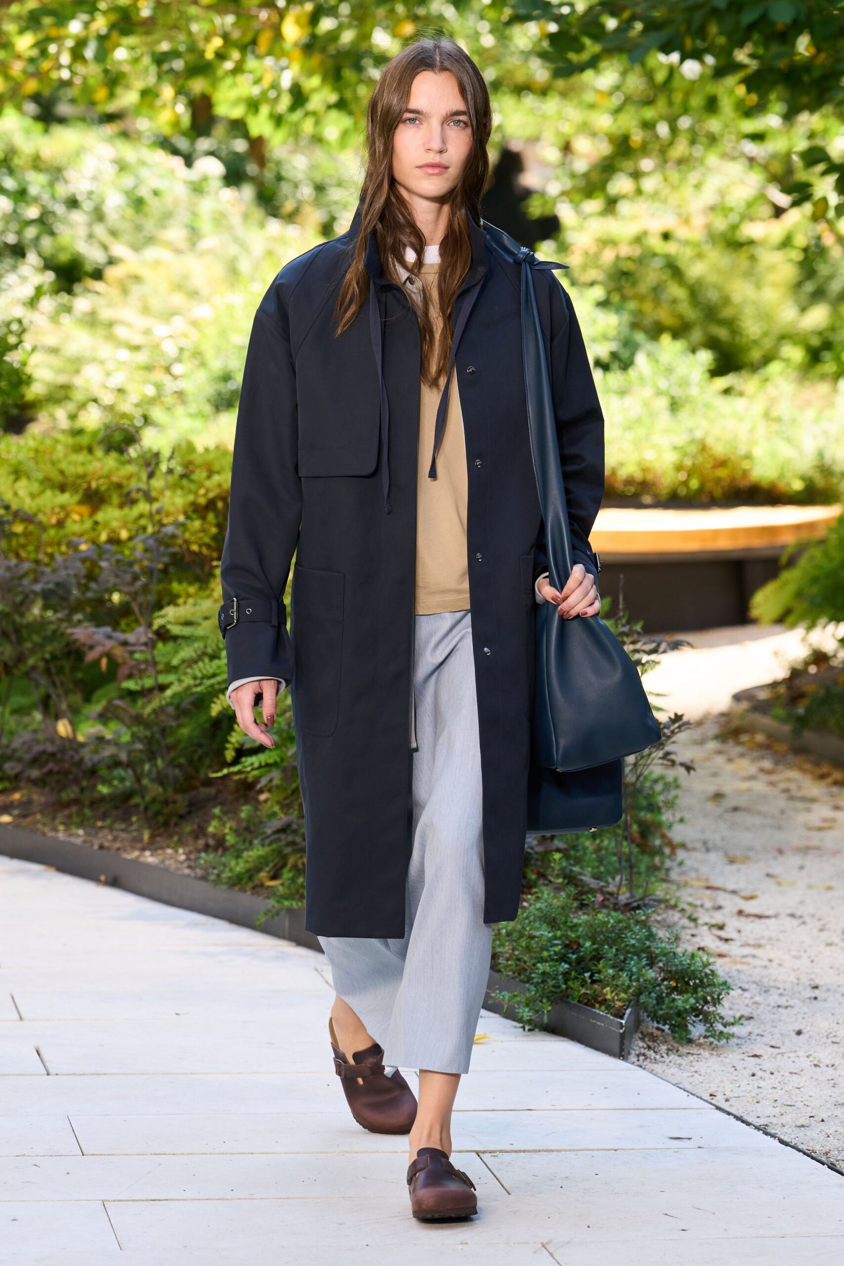 black coat beige top gray pants