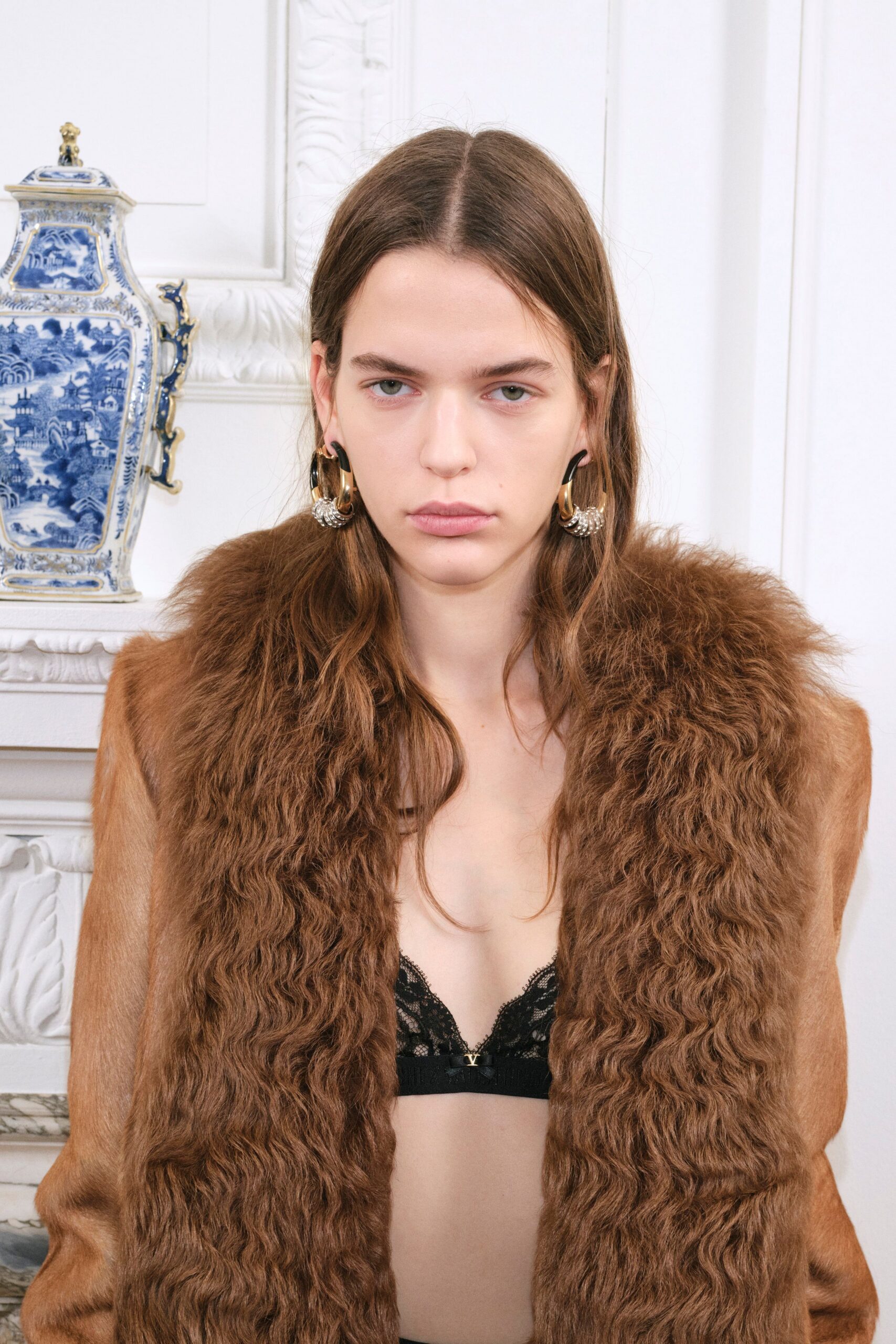 brown fur coat with black bra