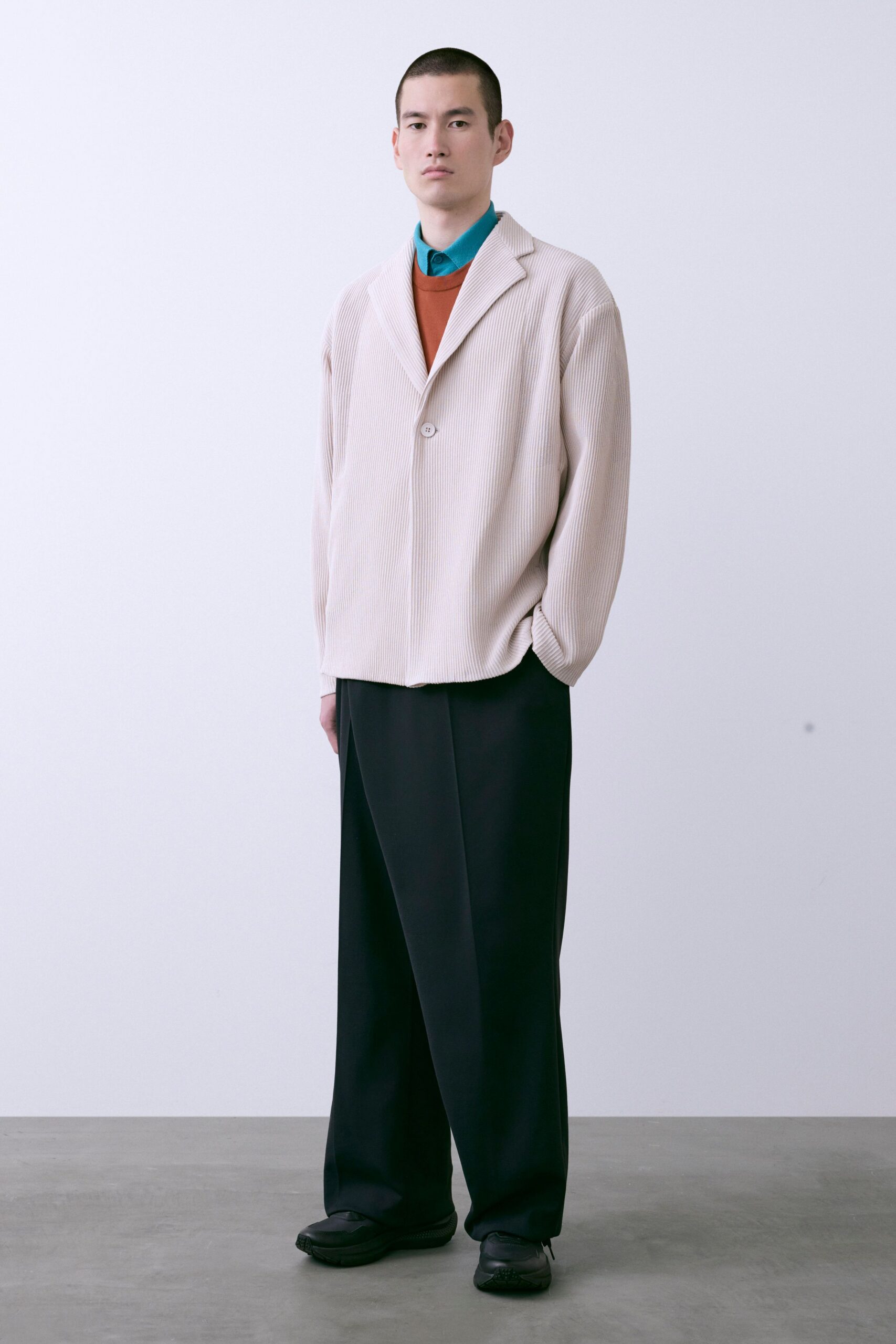 beige blazer blue shirt orange sweater black pants