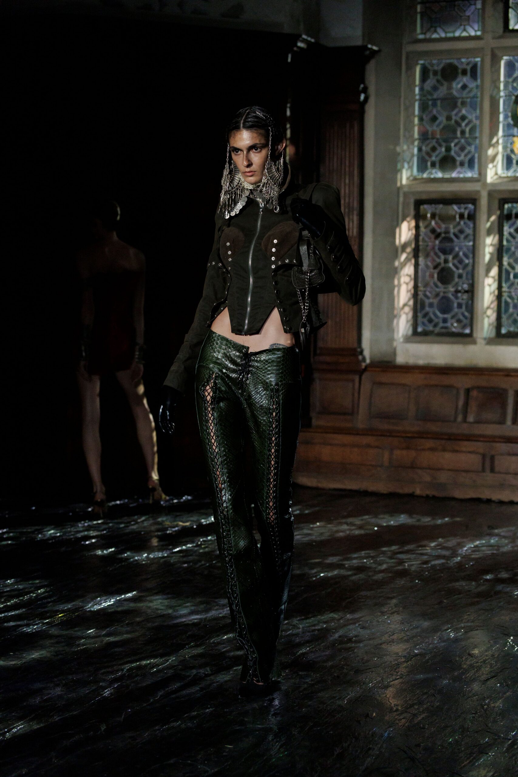 black leather fitted jacket and green pants