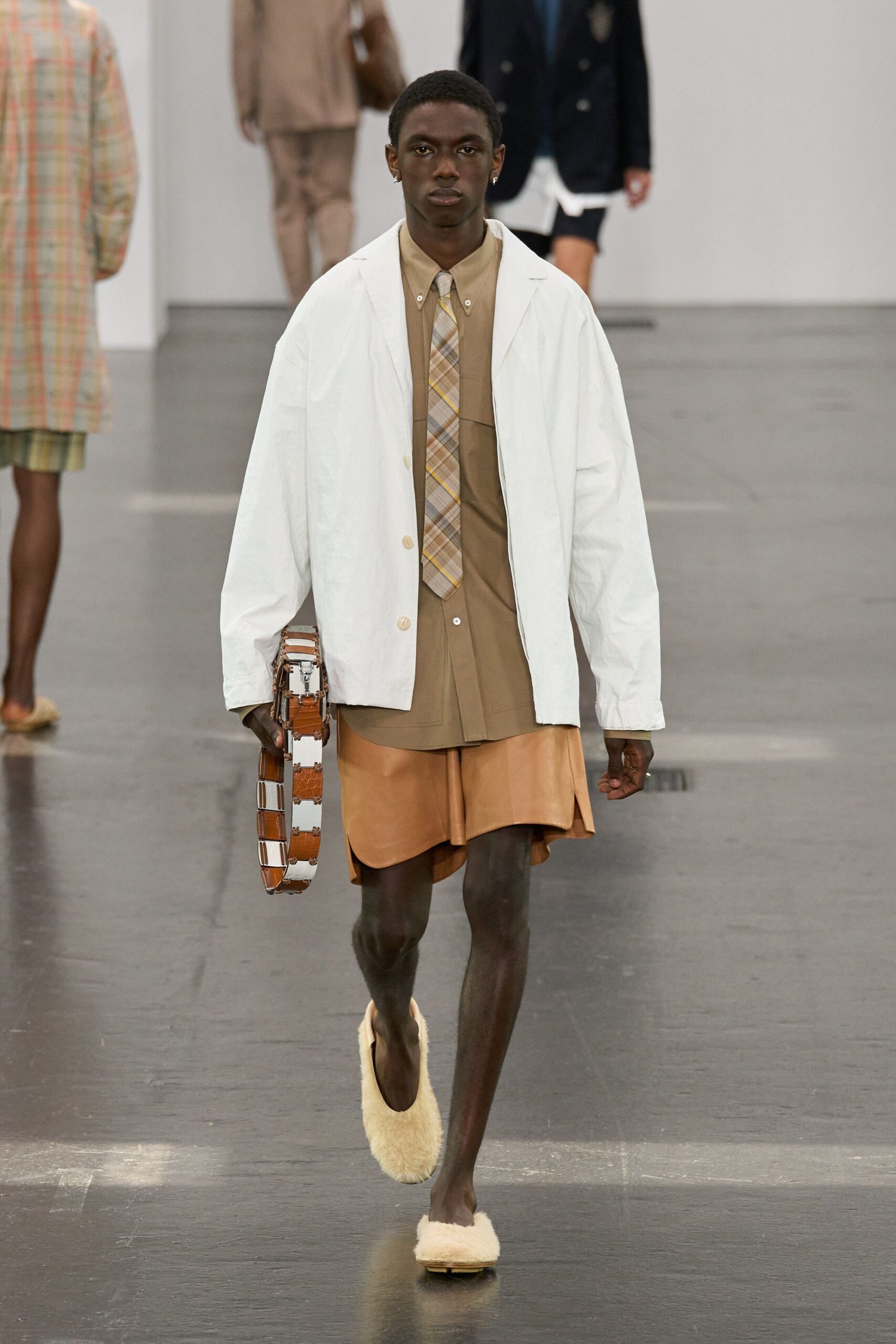 oversized white jacket with beige shirt and brown shorts