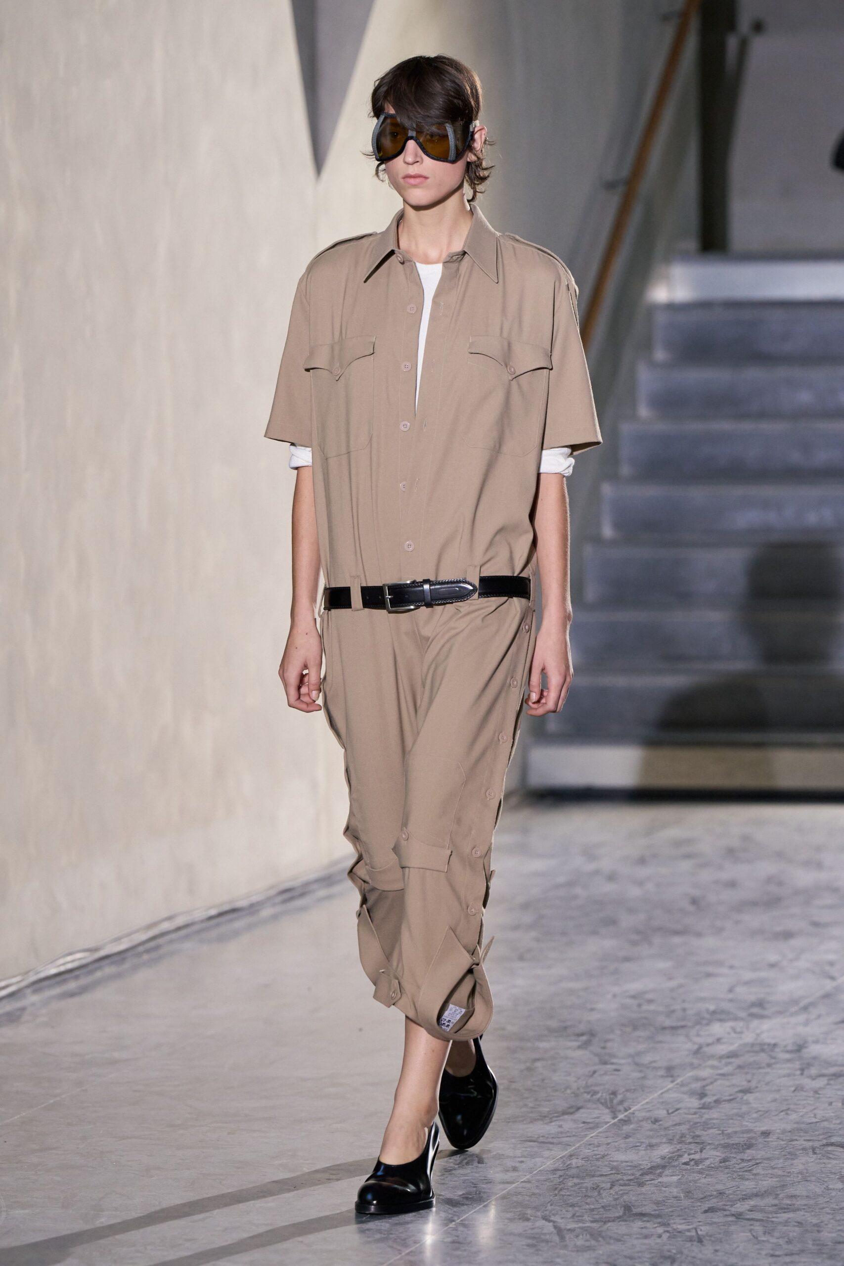 beige relaxed jumpsuit with black accessories
