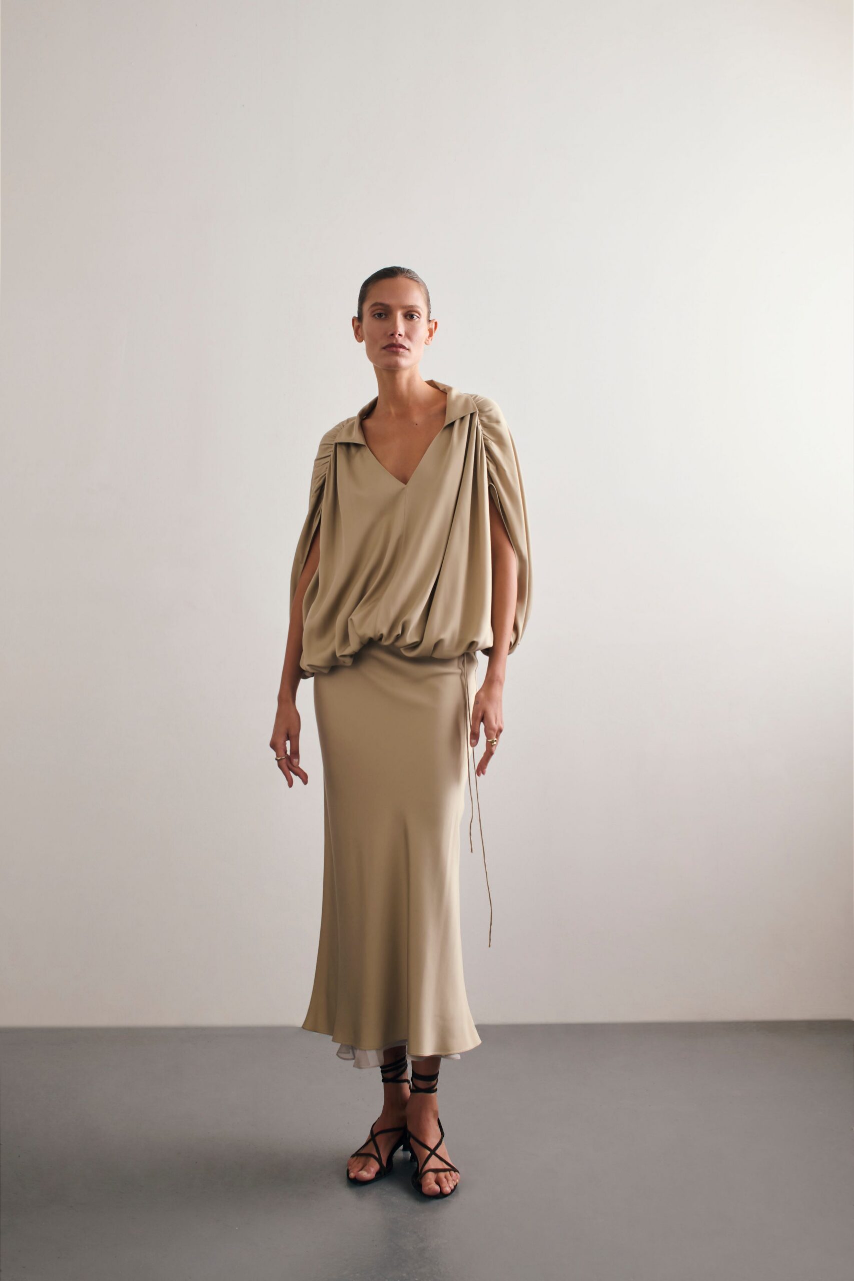 beige draped midi dress with black shoes