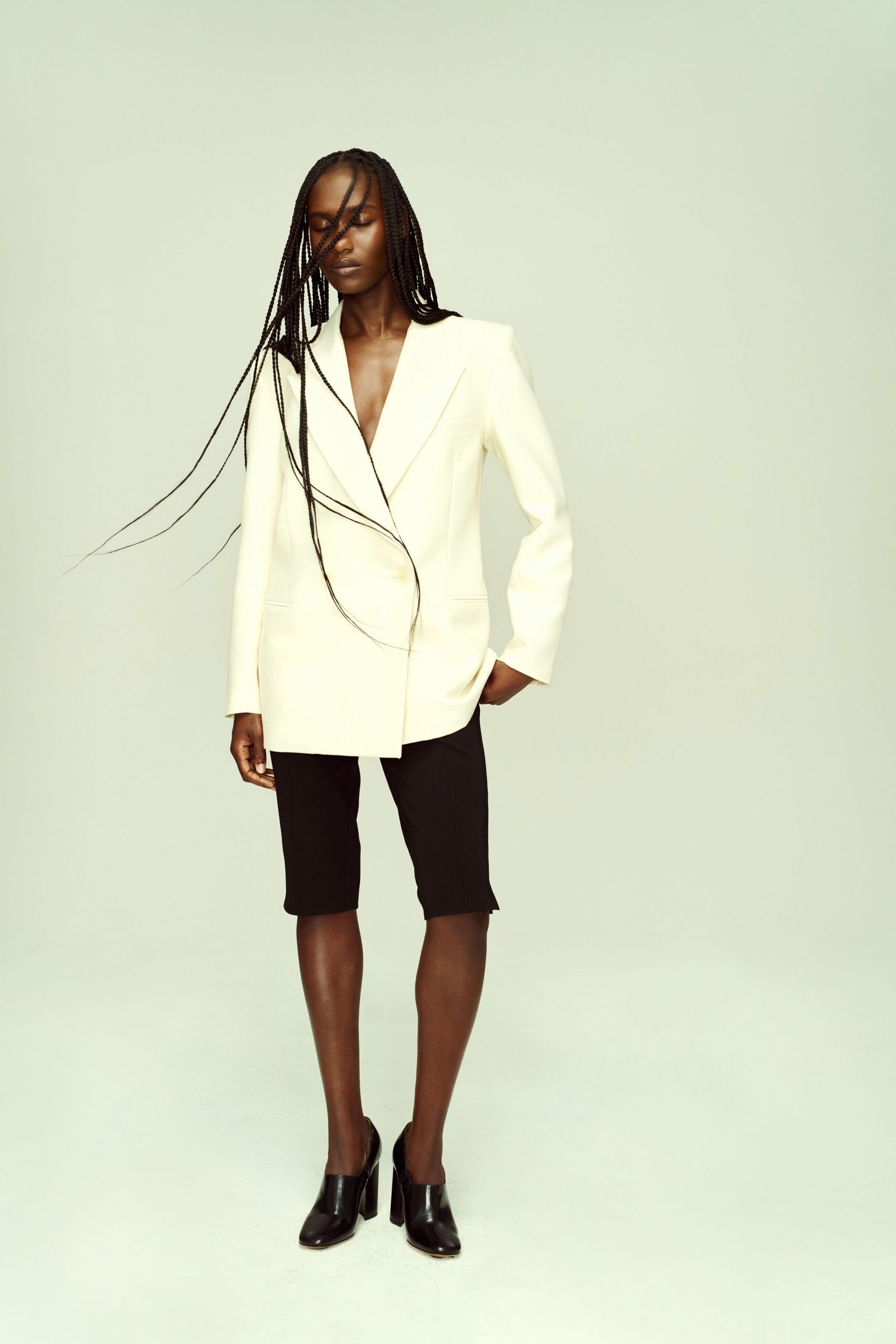 white tailored blazer with black shorts
